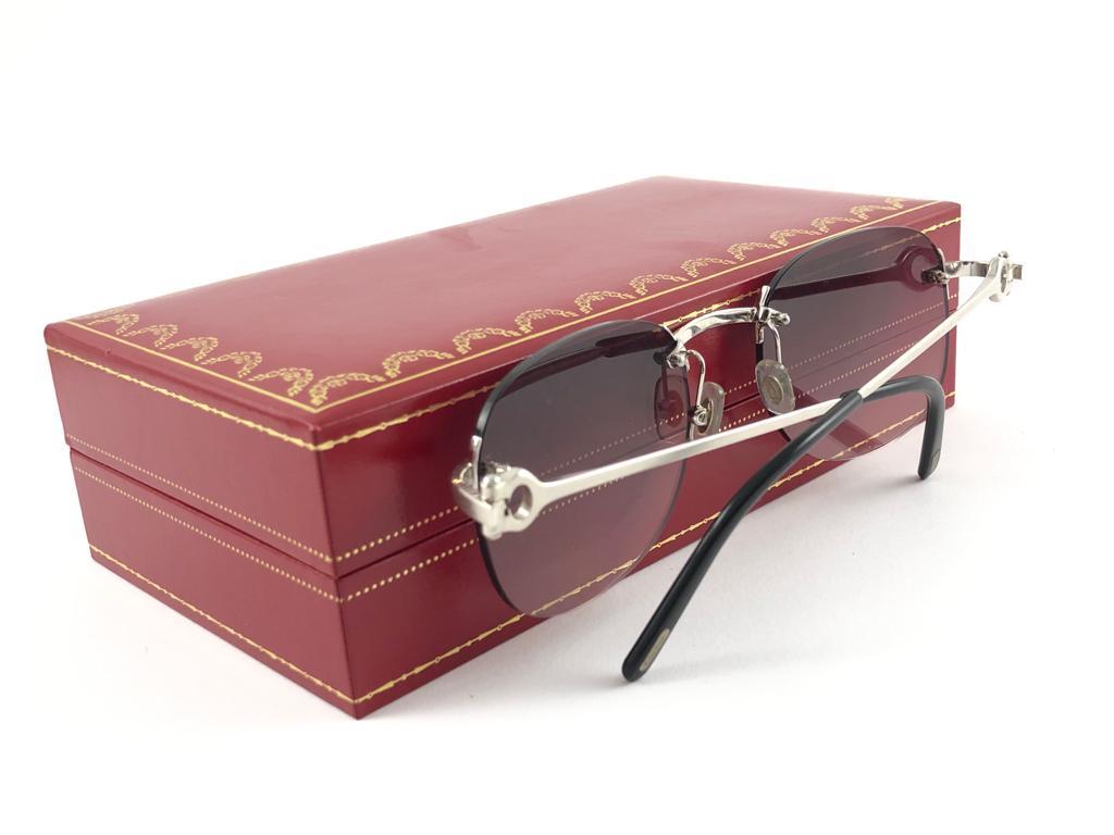 New Cartier unique rimless brushed platine sunglasses with mauve gradient  (uv protection) lenses.   All hallmarks. Cartier silver signs on the ear paddles.  These are like a pair of jewels on your nose.  Beautiful design and a real sign of the