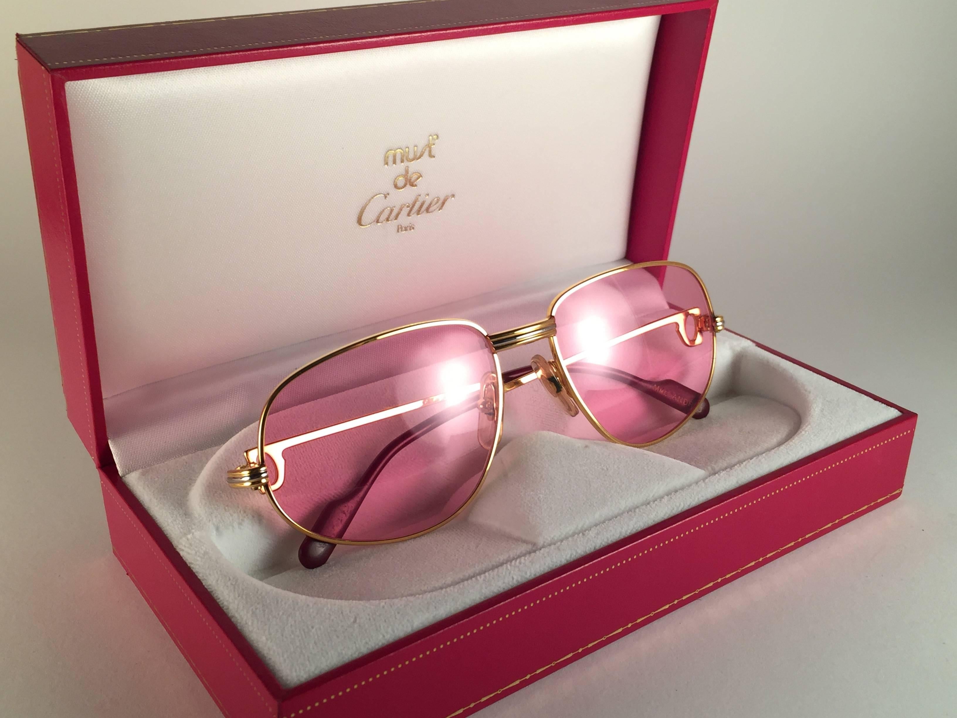 Vintage Cartier Romance Vendome sunglasses with Candy Pink (uv protection)lenses. 
Frame is with the front and sides in yellow and white gold. 
All hallmarks. 
Red enamel with Cartier gold signs on the ear paddles. Both arms sport the C from Cartier