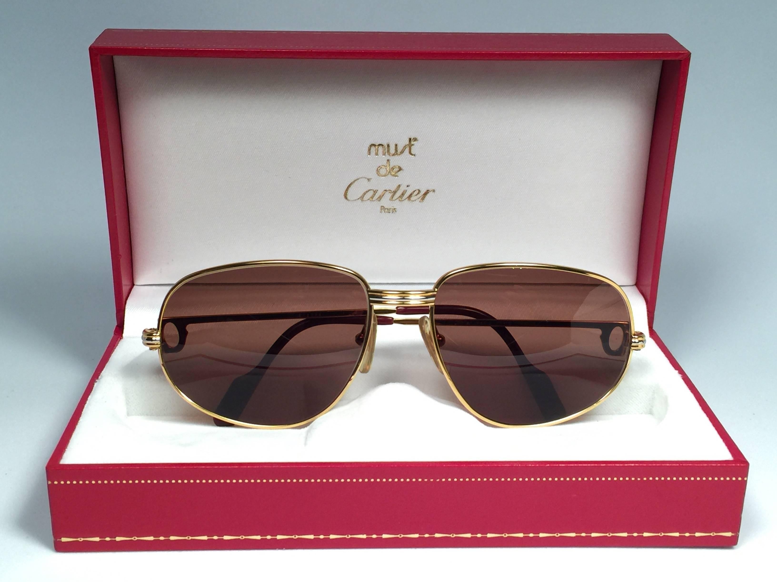 Vintage Cartier Romance Vendome sunglasses with solid brown  (uv protection)lenses. 
Frame is with the front and sides in yellow and white gold. 
All hallmarks. 
Red enamel with Cartier gold signs on the ear paddles. Both arms sport the C from