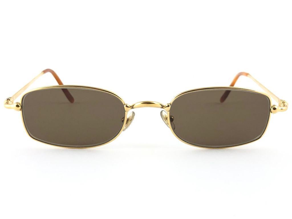 New 1990 Cartier Sasdir 51 MM Sunglasses with brown (uv protection) lenses.  All hallmarks. Cartier gold signs on the ear paddles. These are like a pair of jewels on your nose. Beautiful design and a real sign of the times. Original Cartier hard