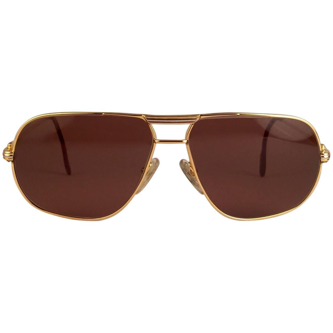New 1988 Cartier Aviator Tank sunglasses with new honey brown (uv protection)
Frame is with the front and sides in yellow and white gold. 
All hallmarks. rRd enamel with cartier gold signs on the earpaddles. so classy, both arms sport the C from