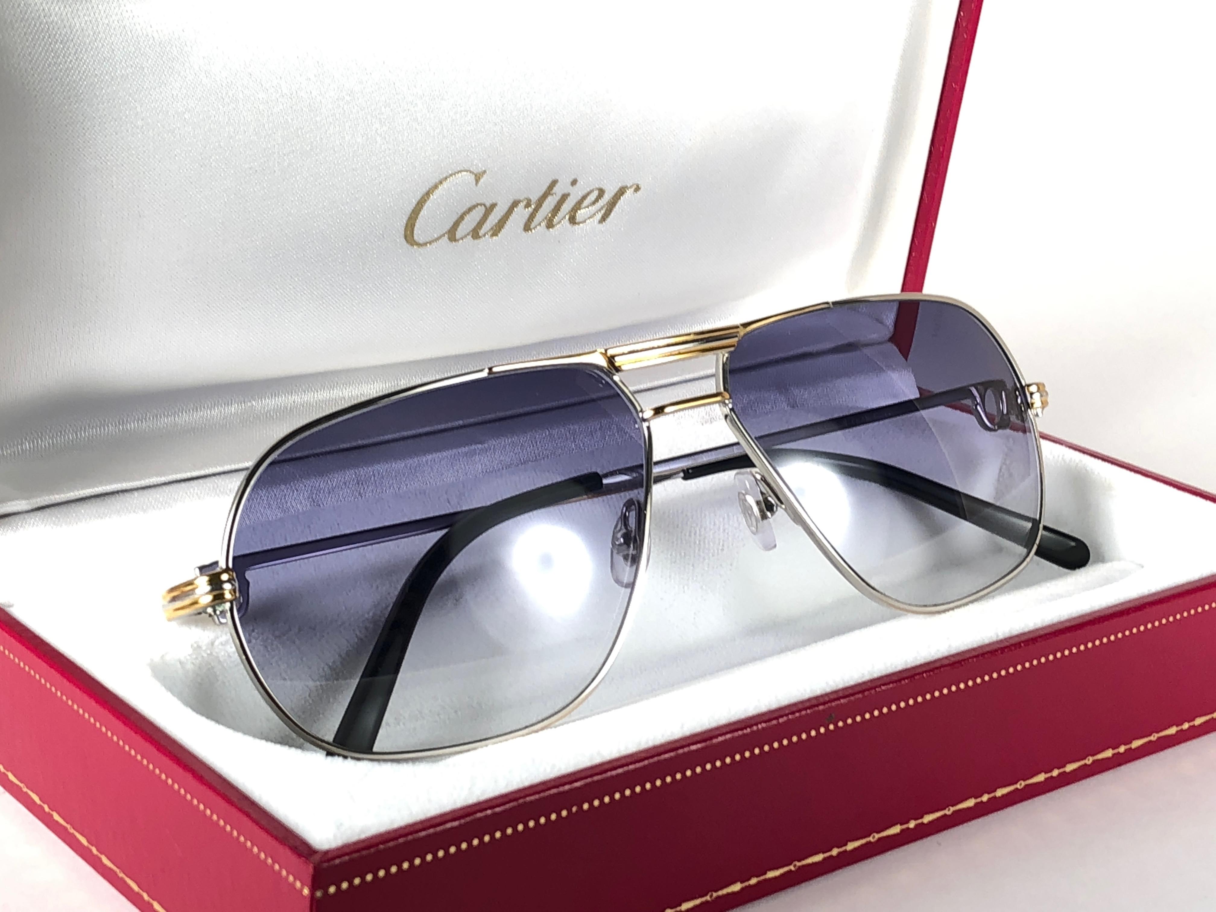 Mint 1988 Cartier Aviator Tank Platinum sunglasses with blue gradient (uv protection)lenses. 
Frame is with the front and sides in yellow and white gold. All hallmarks. Cartier gold signs on the ear paddles. Both arms sport the C from Cartier on the