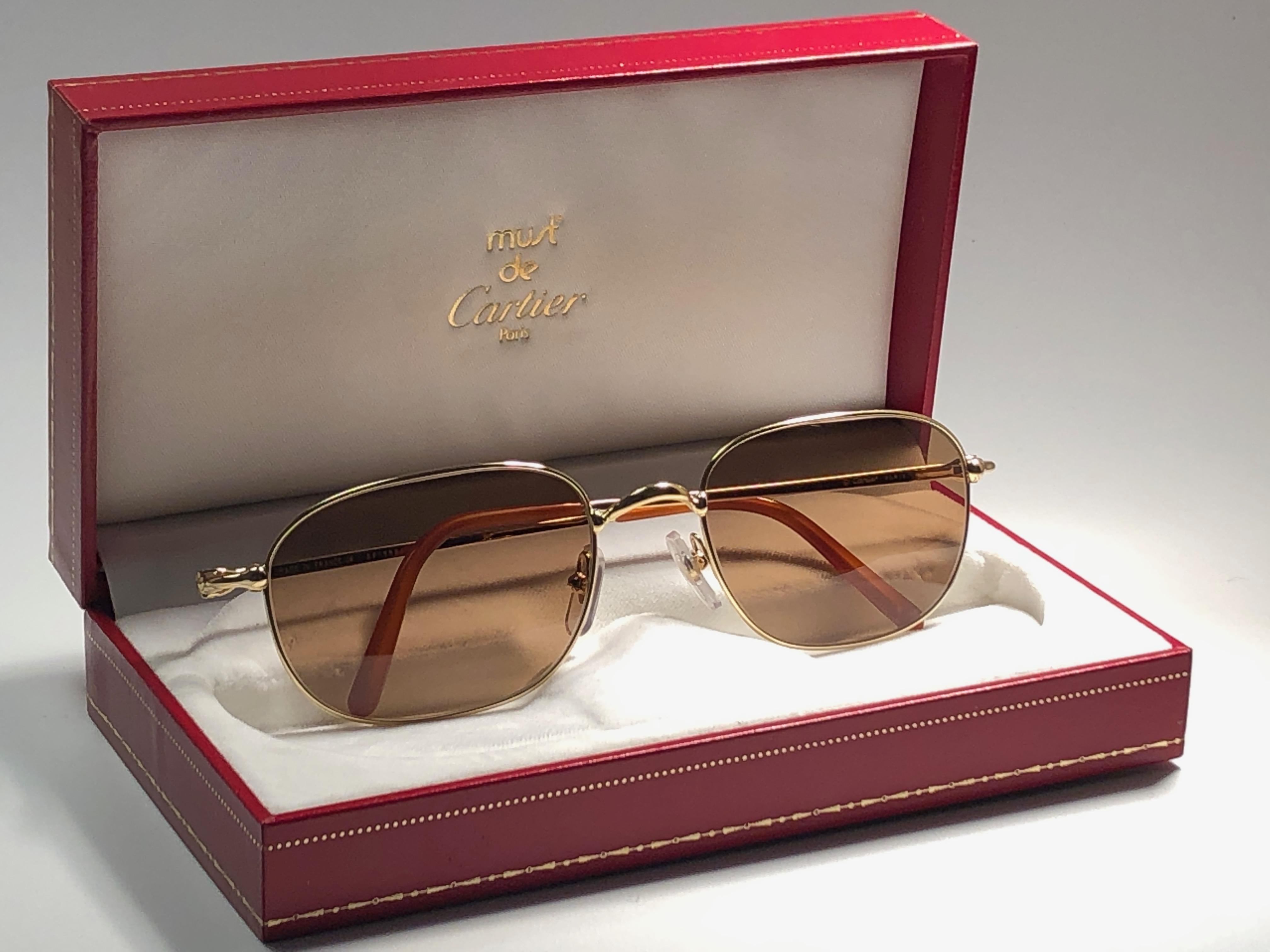 New 1990 Cartier Vesta Sunglasses with brown (uv protection) lenses. All hallmarks. Cartier gold signs on the ear paddles. These are like a pair of jewels on your nose. 
Please notice that this sunglasses are nearly 30 years old and could show minor
