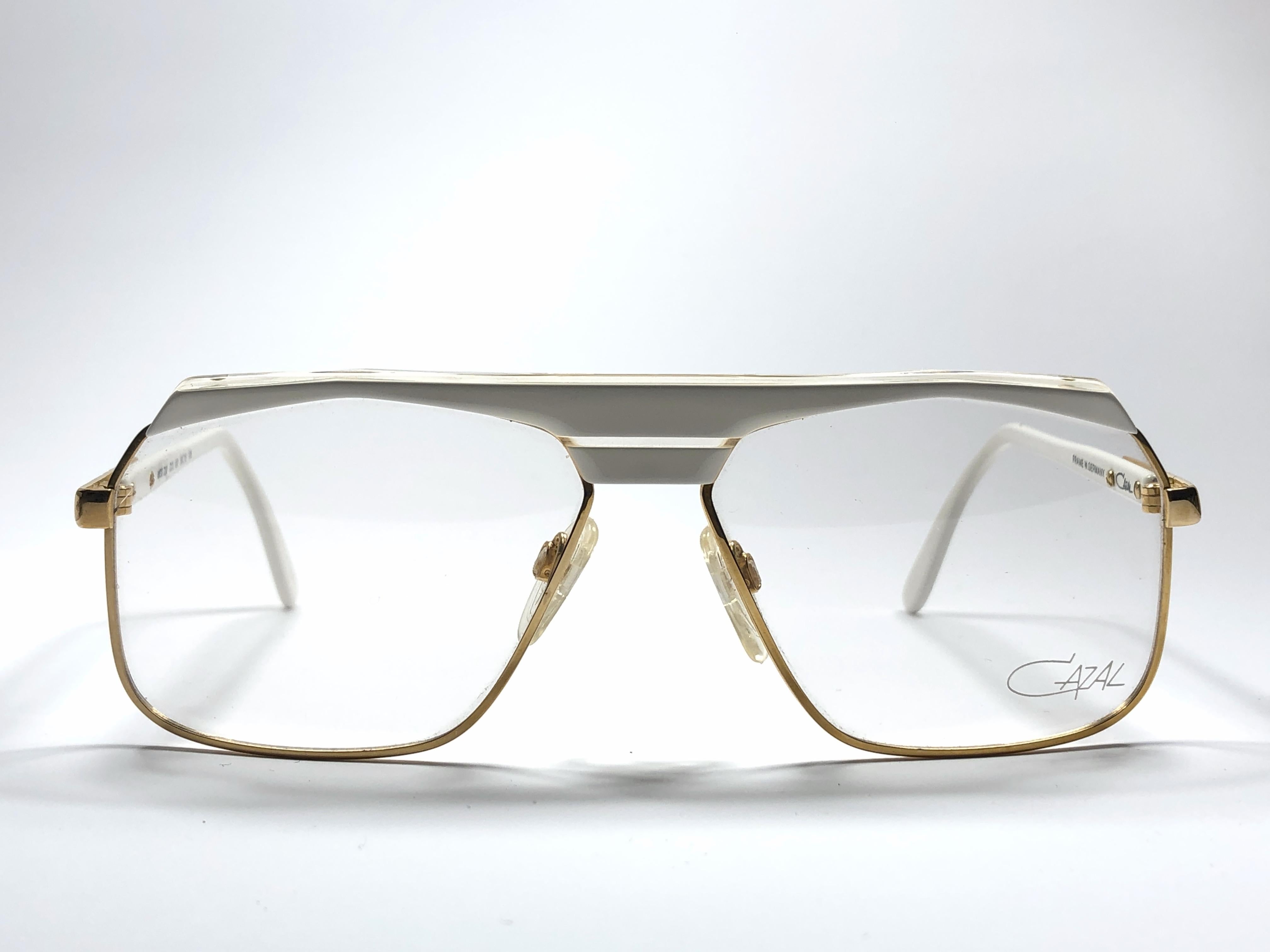 New Vintage Cazal 730 white with gold details frame. Perfect for reading spectacles. 

Comes with its original Cazal case. This item may show minor sign of wear due to storage.

Made in West Germany.