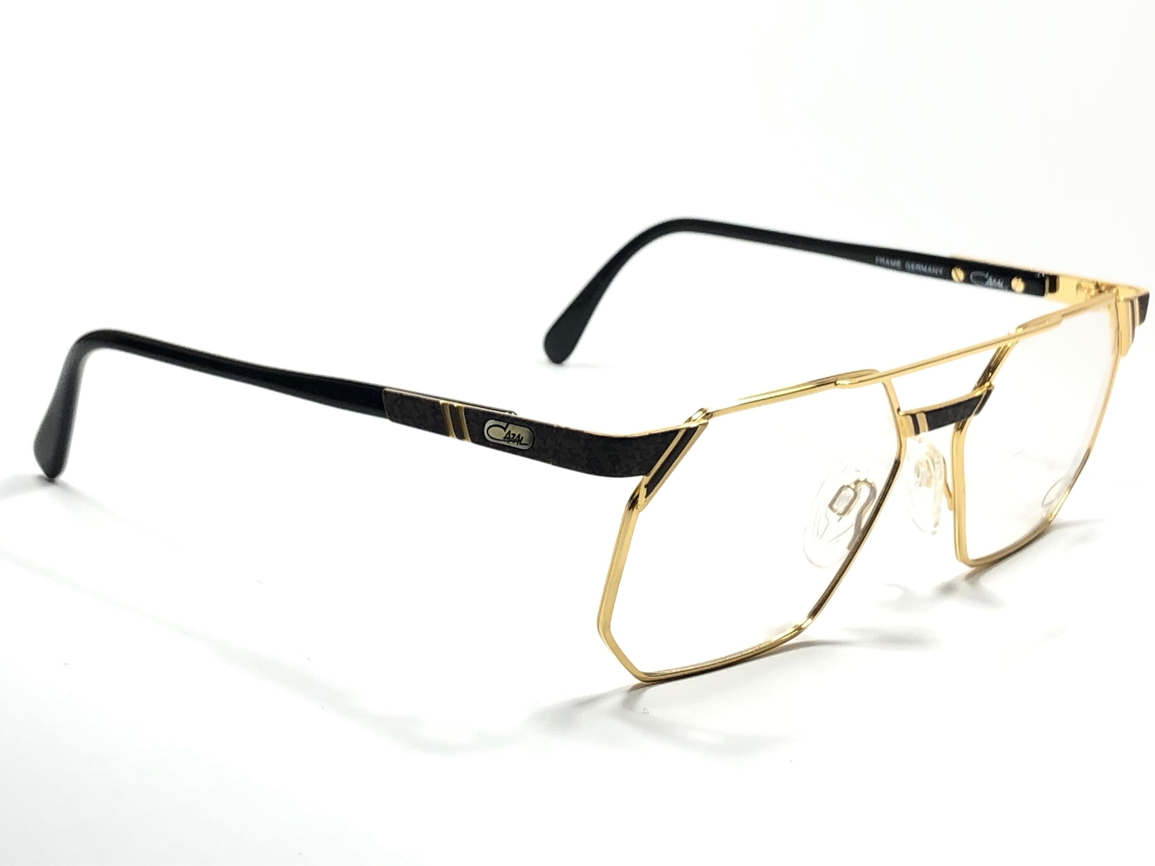 New Vintage Cazal 743 gold with black details frame. 

Comes with its original Cazal case. This item may show minor sign of wear due to storage.

Made in West Germany.