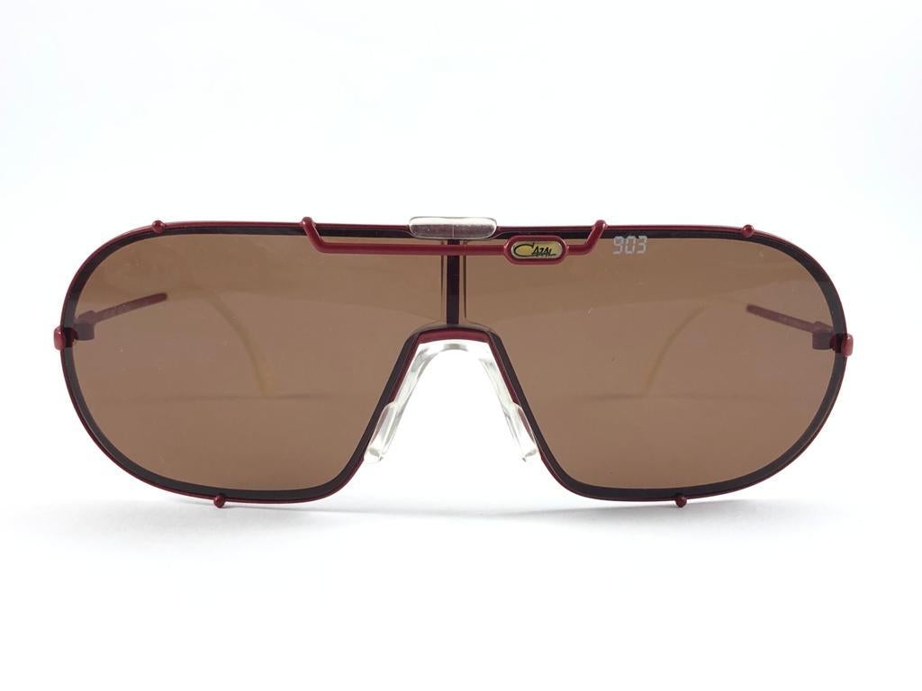 New Rare and Iconic Vintage Cazal Red & White Frame Holding a Medium Brown Mono Lense sunglasses.
A seldom and unique piece in this new, never displayed or worn condition. 
This pair of Cazal sunglasses is an absolute showstopper.
This pair may show