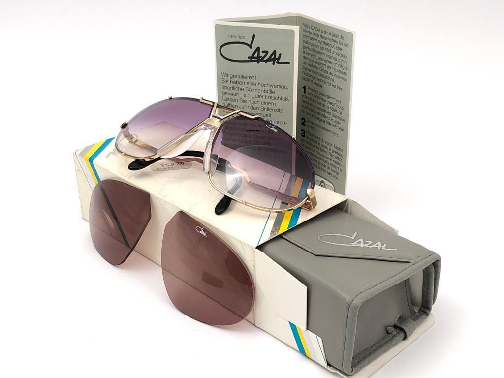 New Vintage Cazal Collectors Item Oversized Gold Frame. 

Brown Gradient Lenses With Light Wear Due To Storage.

Full Set. Original Case, Spare Set Of Lenses And Cazal Ad Paper.

Made In Germany.

Measurements 

Front : 14 Cms

Lens Height : 5