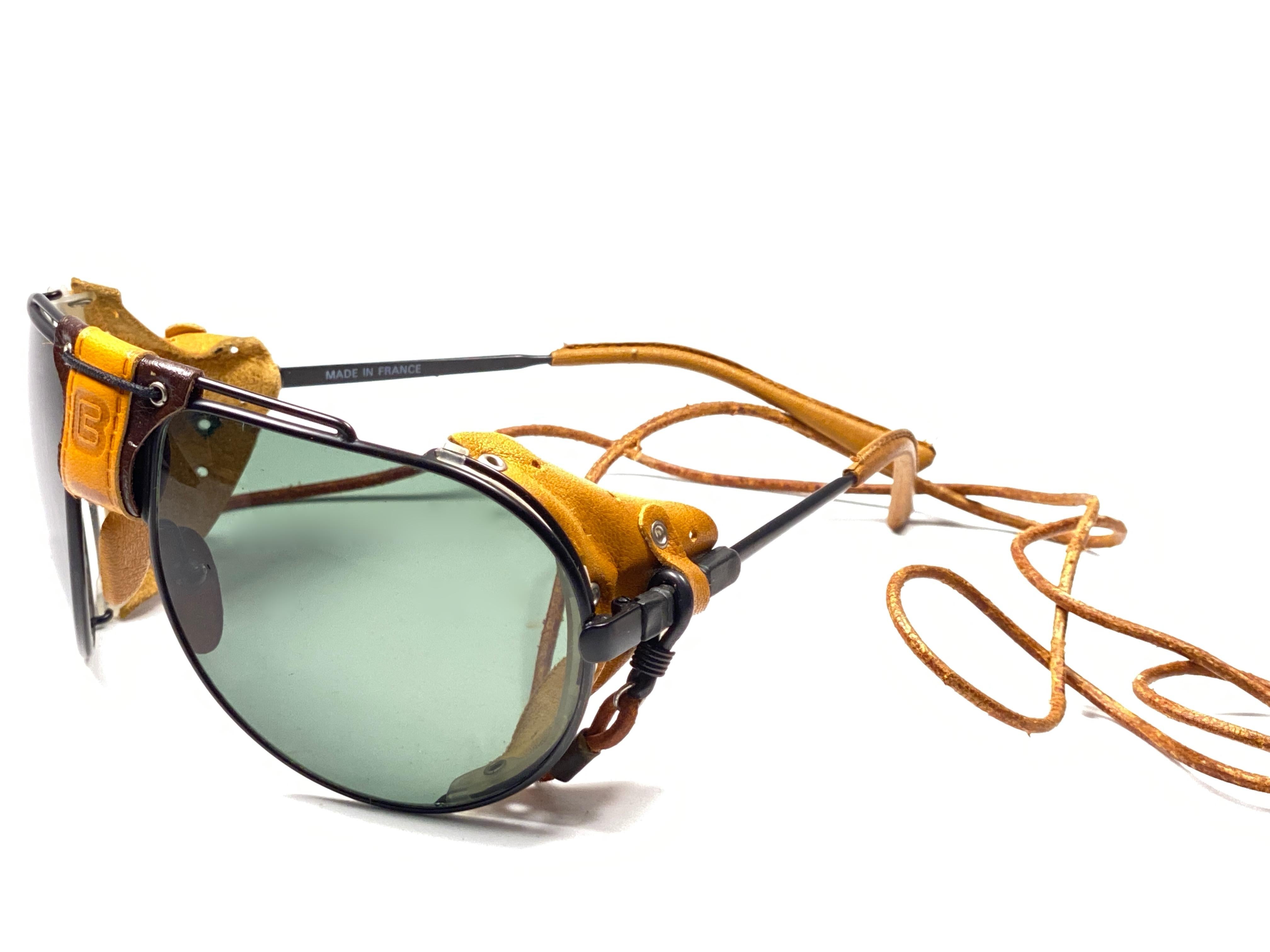 New Vintage Cebe Dakar black aviator with leather accents on nose bridge, sides and removable cord sunglasses. From the very same series as the ones worn by the great Miles Davis.

Sturdy and cool frame sporting a pair of RB3 green lenses. 

Never