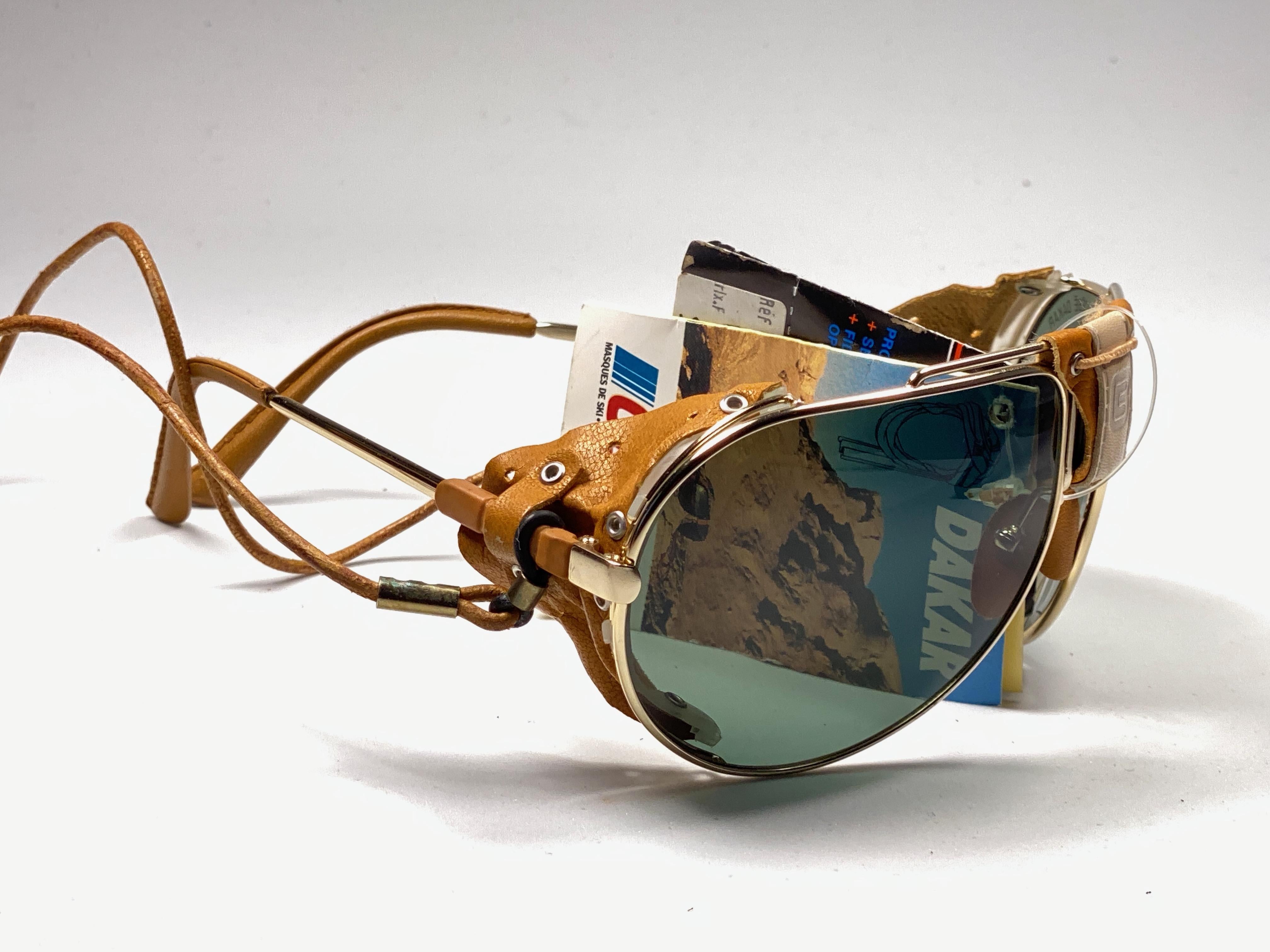 New Vintage Cebe Dakar gold aviator with leather accents on nose bridge, sides and removable cord sunglasses. From the very same series as the ones worn by the great Miles Davis.

Sturdy and cool frame sporting a pair of RB3 green lenses. 

Never