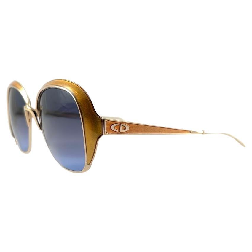 New vintage Christian Dior sunglasses. Ochre enamel details over a gold frame.
Blue gradient lenses.
New, never worn or displayed this item may show light sign of wear due to storage.

Made in Austria

Front                                 13.5 cms