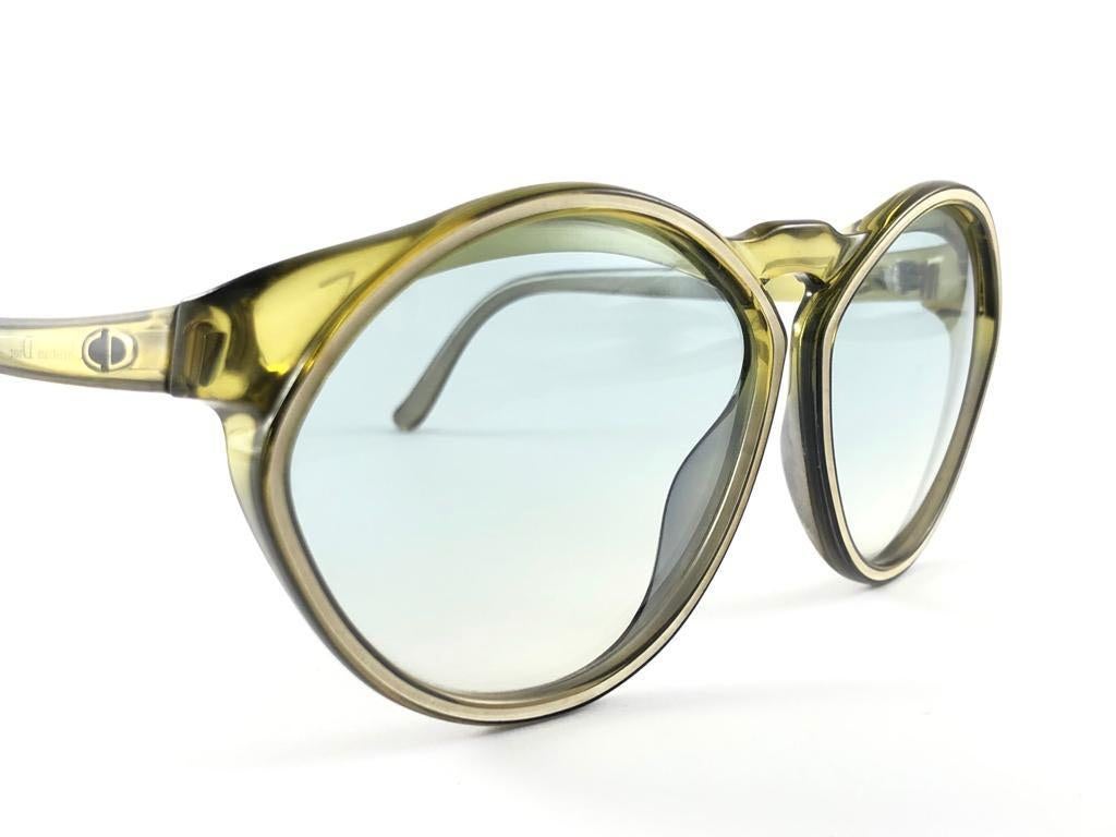 New Vintage Christian Dior 2156 40 Green with beige accents frame with spotless light green lenses.   
Made in Germany.  
Produced and design in 1970's.  
New, never worn or displayed. Comes with its original silver Christian Dior Lunettes