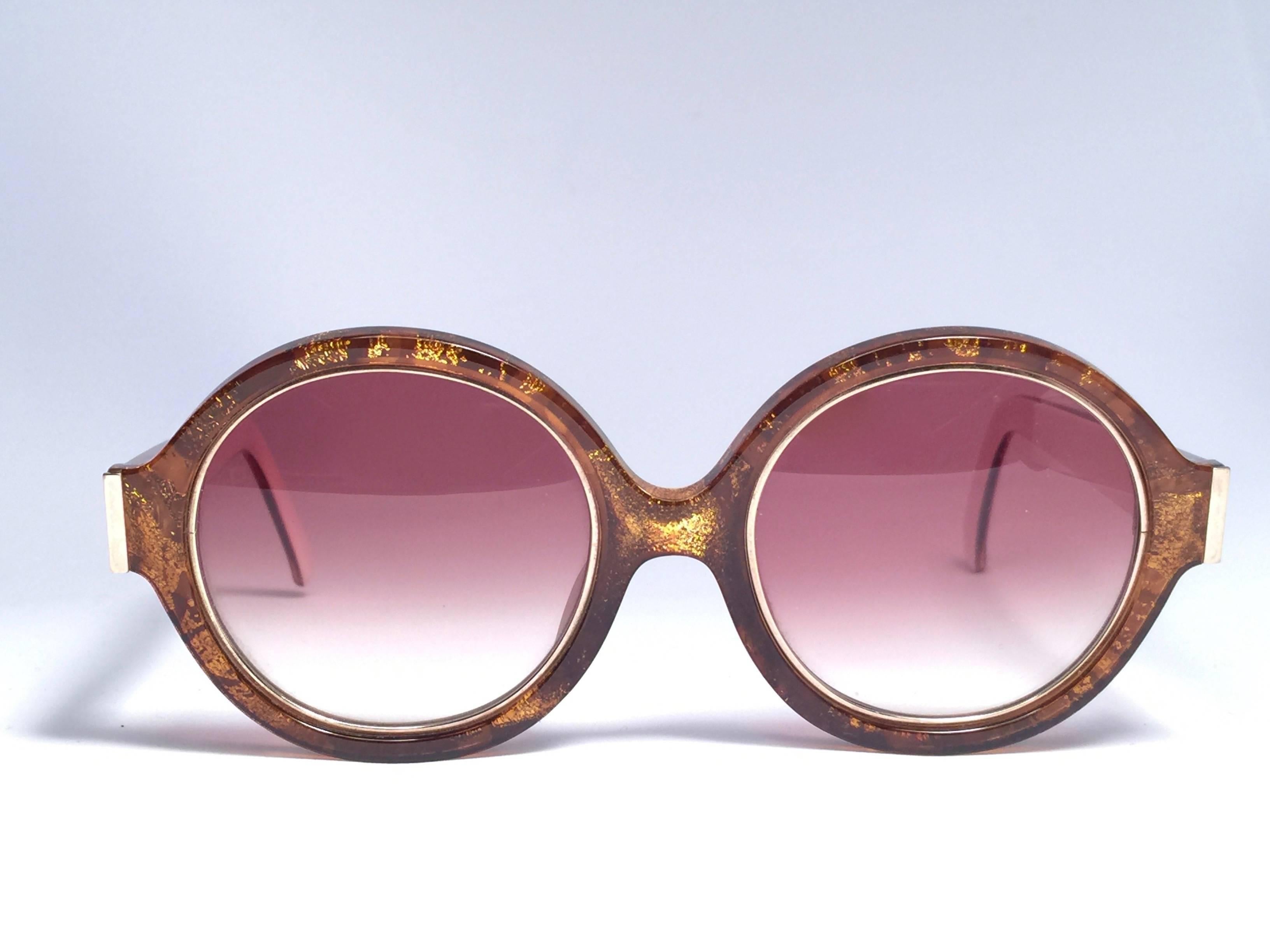 New Vintage Christian Dior 2446 40 Translucent amber mosaic with gold inserts frame sporting spotless brown gradient lenses. 

Made in Germany.

Produced and design in 1970's.

A collector’s piece!

New, never worn or displayed. Comes with its