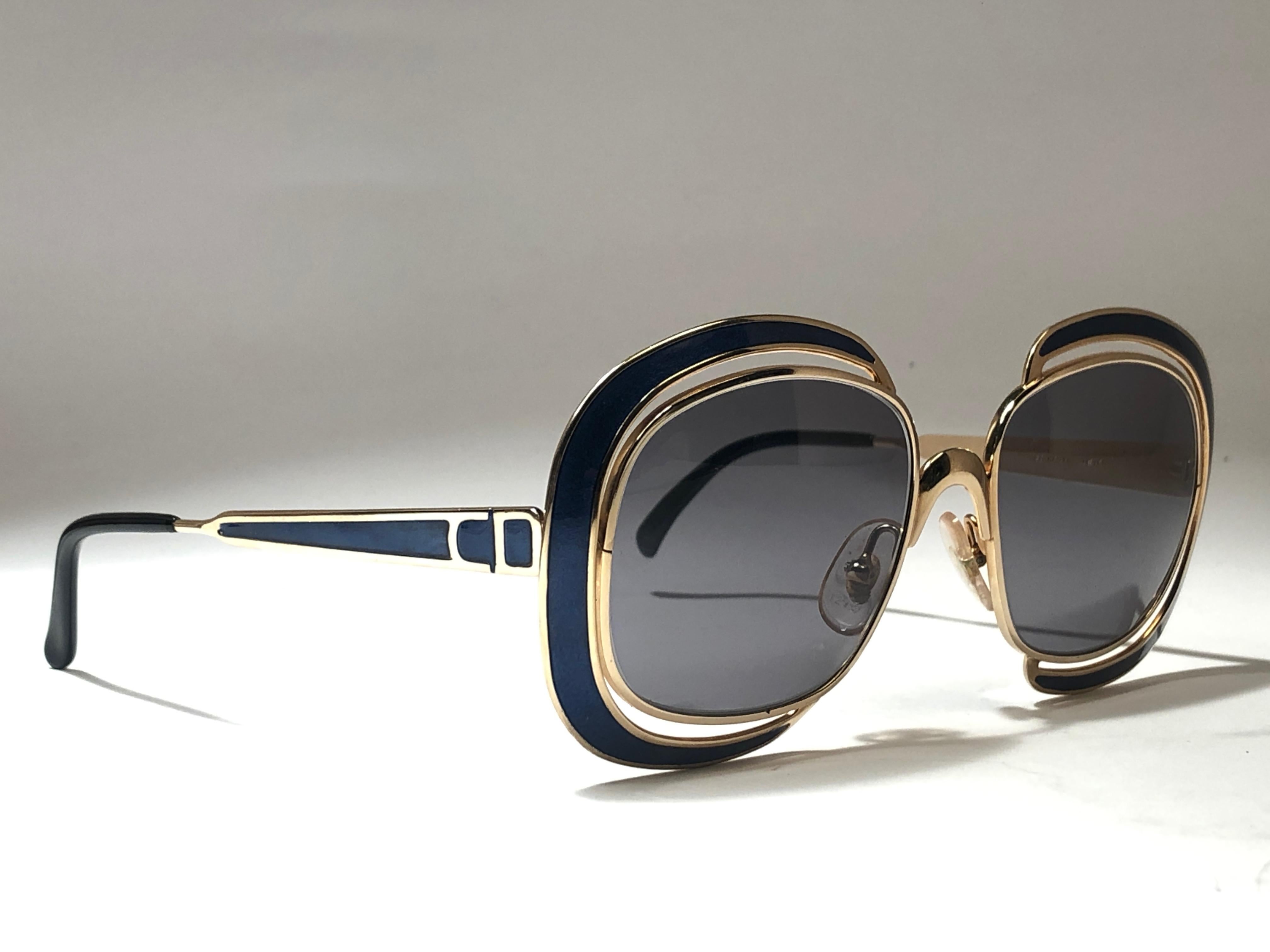 New vintage Christian Dior sunglasses. Blue enamel details over a gold frame.

Grey lenses.

Comes with it original CD sleeve.

New, never worn or displayed this item may show light sign of wear due to storage.

Made in Austria
