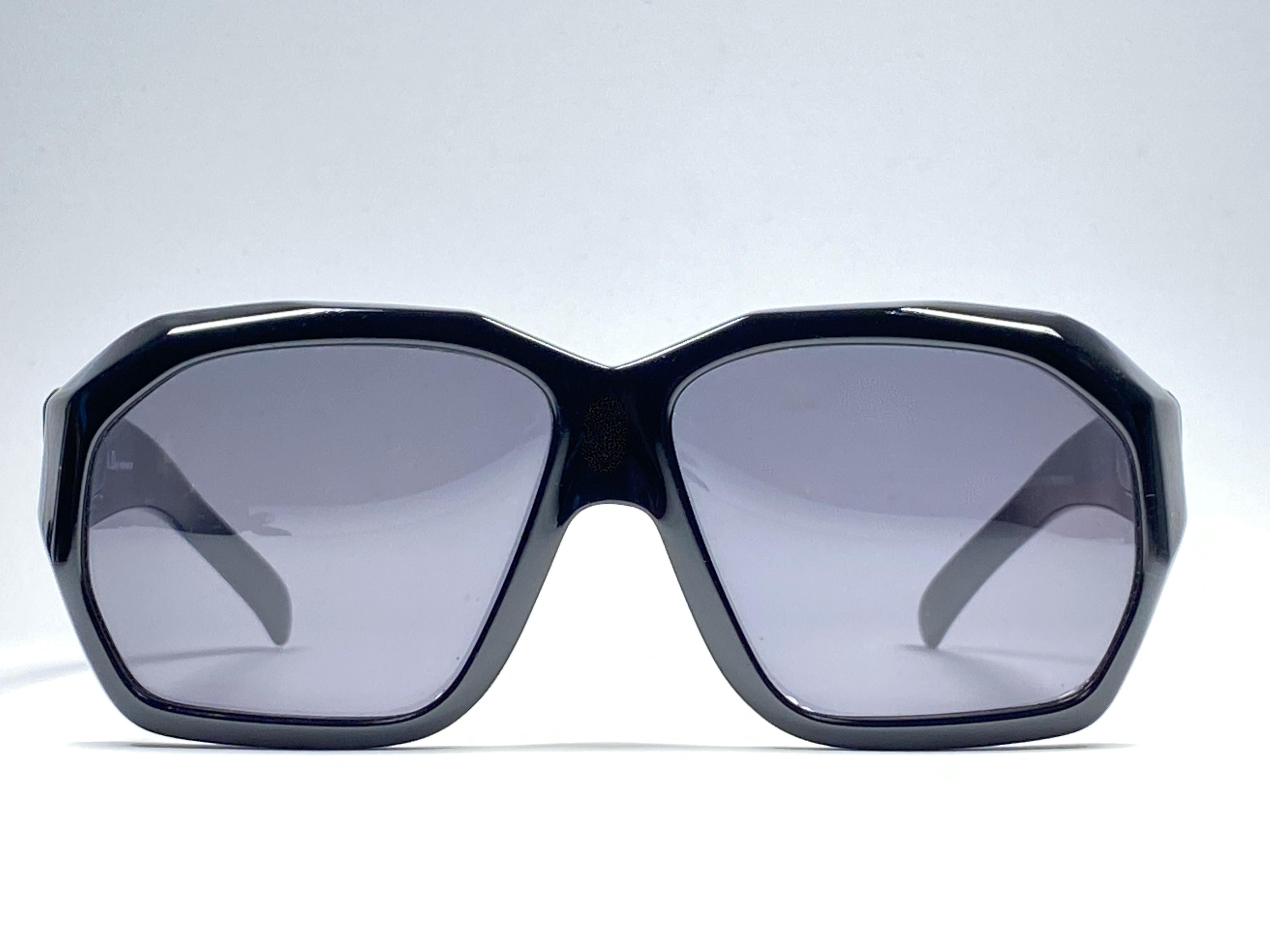 
New Vintage Christian Dior 2466 91 Sunglasses Super Oversized sleek black frame with spotless deep grey lenses. Design and produced in 1970’s. 

Made by Optyl. 

Manufactured in Germany.

This item could show  minor sign of wear due to