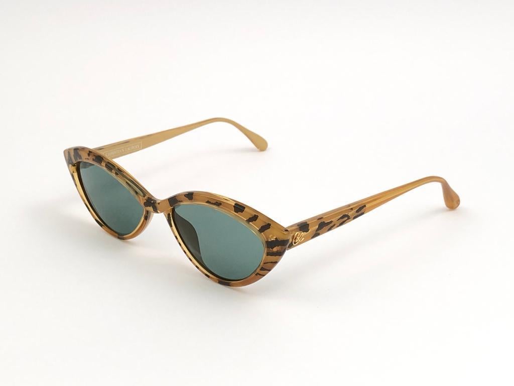 Rare pair of New vintage Christian Lacroix Cat Eye sunglasses.   
Brown & Ocher pattern frame holding a pair of spotless lenses.
This item may show a minor sign of wear due to more than 30 years of storage
 New, never worn or displayed. 

Made in