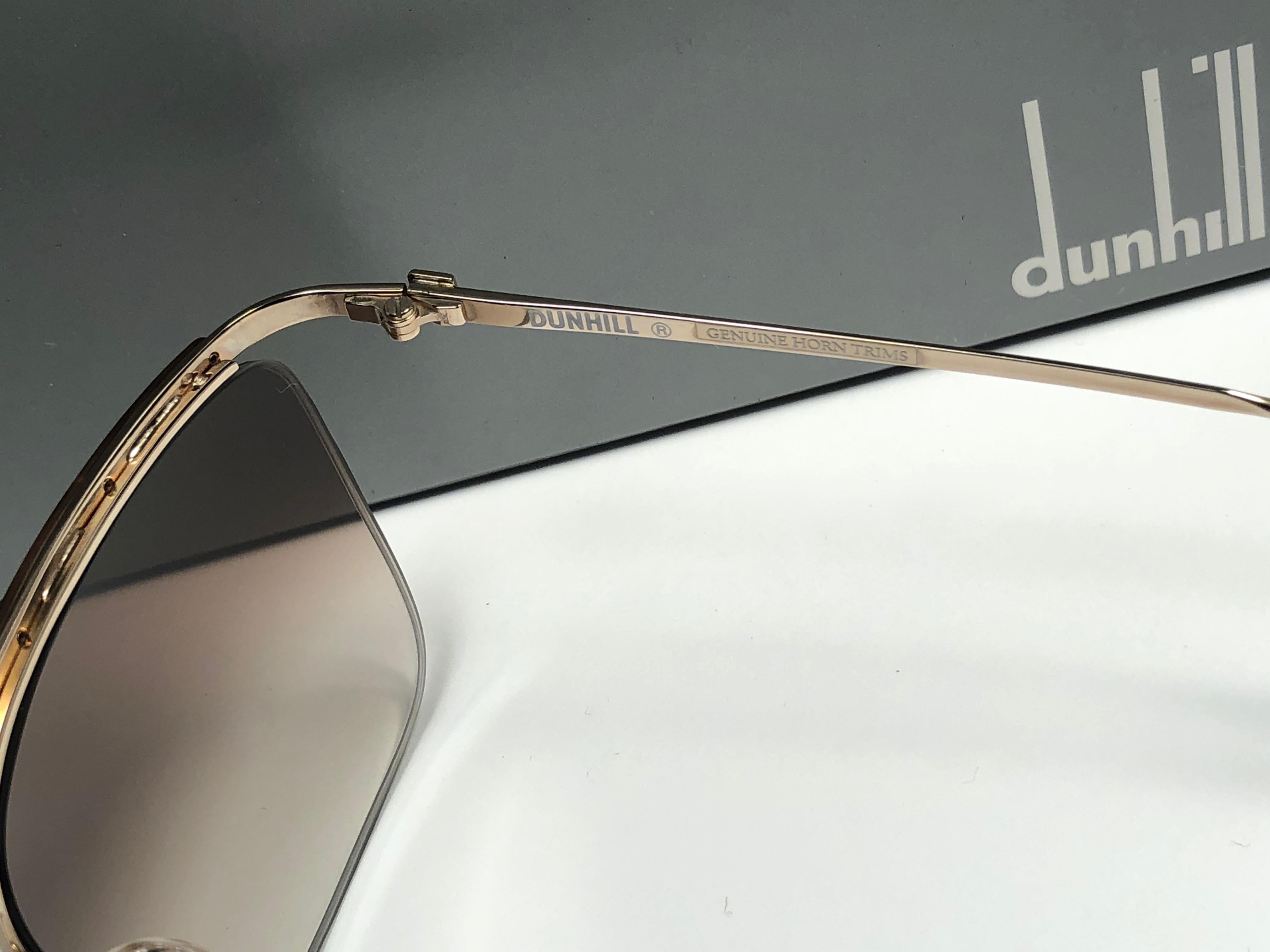 
New 1980 Dunhill gold with real horn trims frame Sunglasses with brown  (uv protection) lenses. 
These are like a pair of jewels on your nose.
Beautiful design and a real sign of the times. 
Original Dunhill case.
This piece may show minor sign of