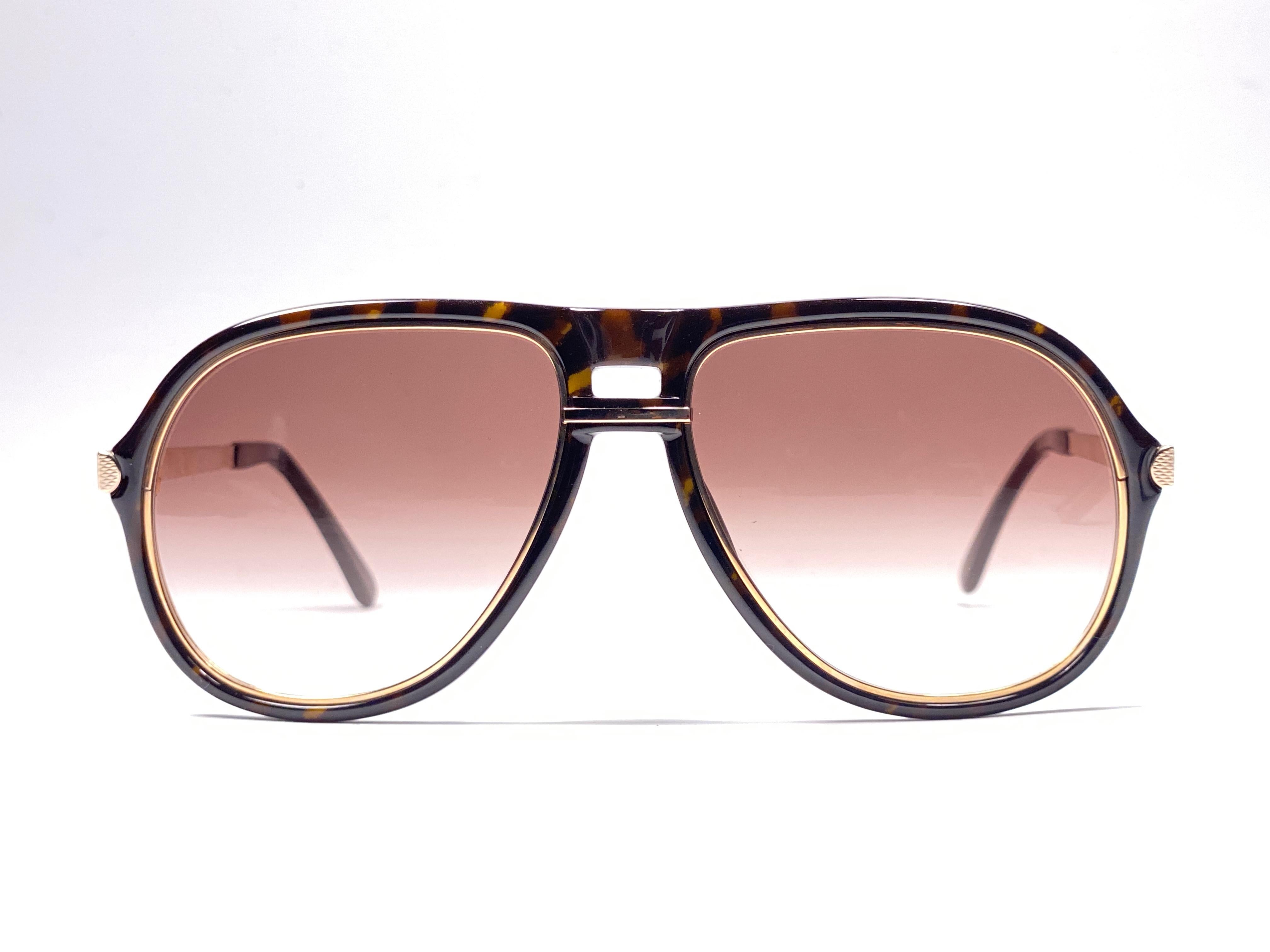 
New 1980 Dunhill oversized dark tortoise frame. 
Light gradient brown (uv protection) lenses. 
These are like a pair of jewels on your nose.
Beautiful design and a real sign of the times. 
Original Dunhill case.
This piece may show minor sign of