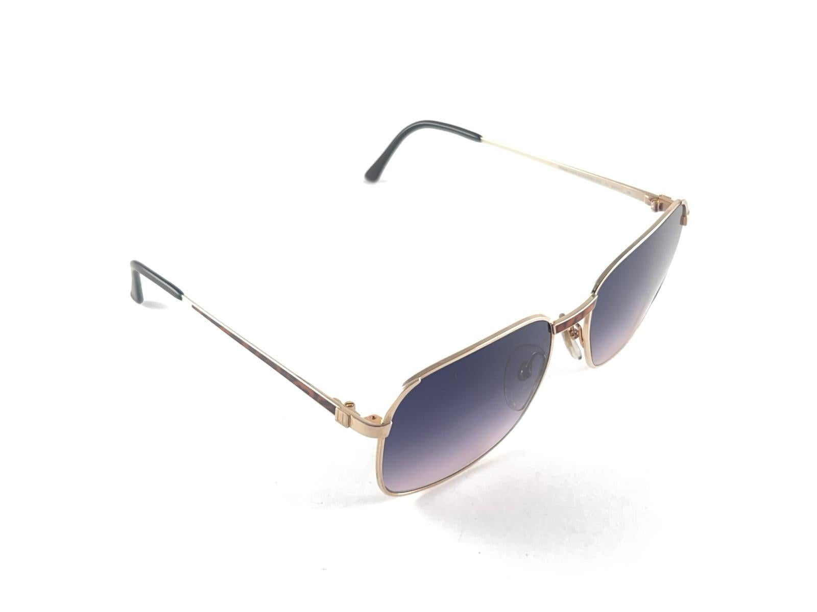 
New 1980 Dunhill gold with real horn trims frame Sunglasses holding gradient Purple lenses. 
These are like a pair of jewels on your nose.
Beautiful design and a real sign of the times. 

This piece may show minor sign of wear due to