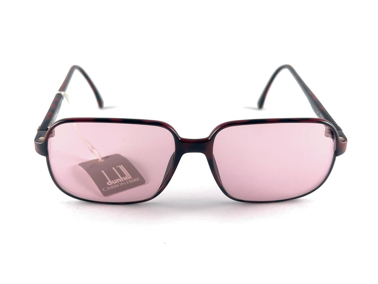 
New 1980 Dunhill  6107 Burgundy Tortoise frame holding Pink Lenses Sunglasses 
Beautiful Design And A Real Sign Of The Times. 
This Piece May Show Minor Sign Of Wear Due To Storage.
1980'S Designed And Produced.



Made In Austria



Front         