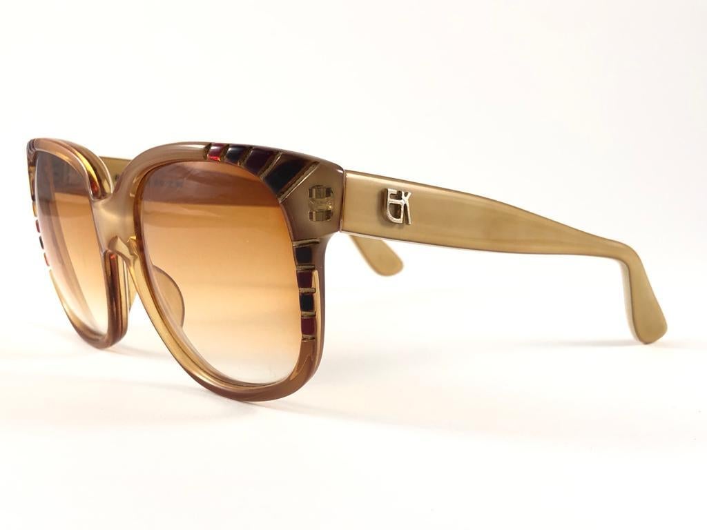 New Vintage Emanuelle Kahn honey beige frame with spotless gradient lenses.  Made in Paris. 
Produced and design in 1980's.  
New, never worn or displayed. Please consider this item is nearly 40 years old and could show minor sign of wear due to