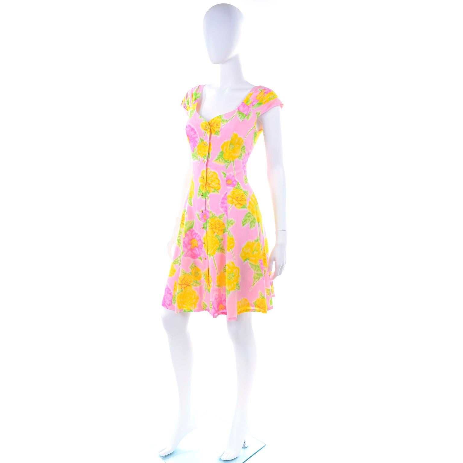 This pretty pink, yellow and green floral Escada dress was designed by Margaretha Ley and was never worn!  The dress still has its original tags attached and is labeled a size 36.  Made in Italy of 100% silk, this lovely dress has pleated cap