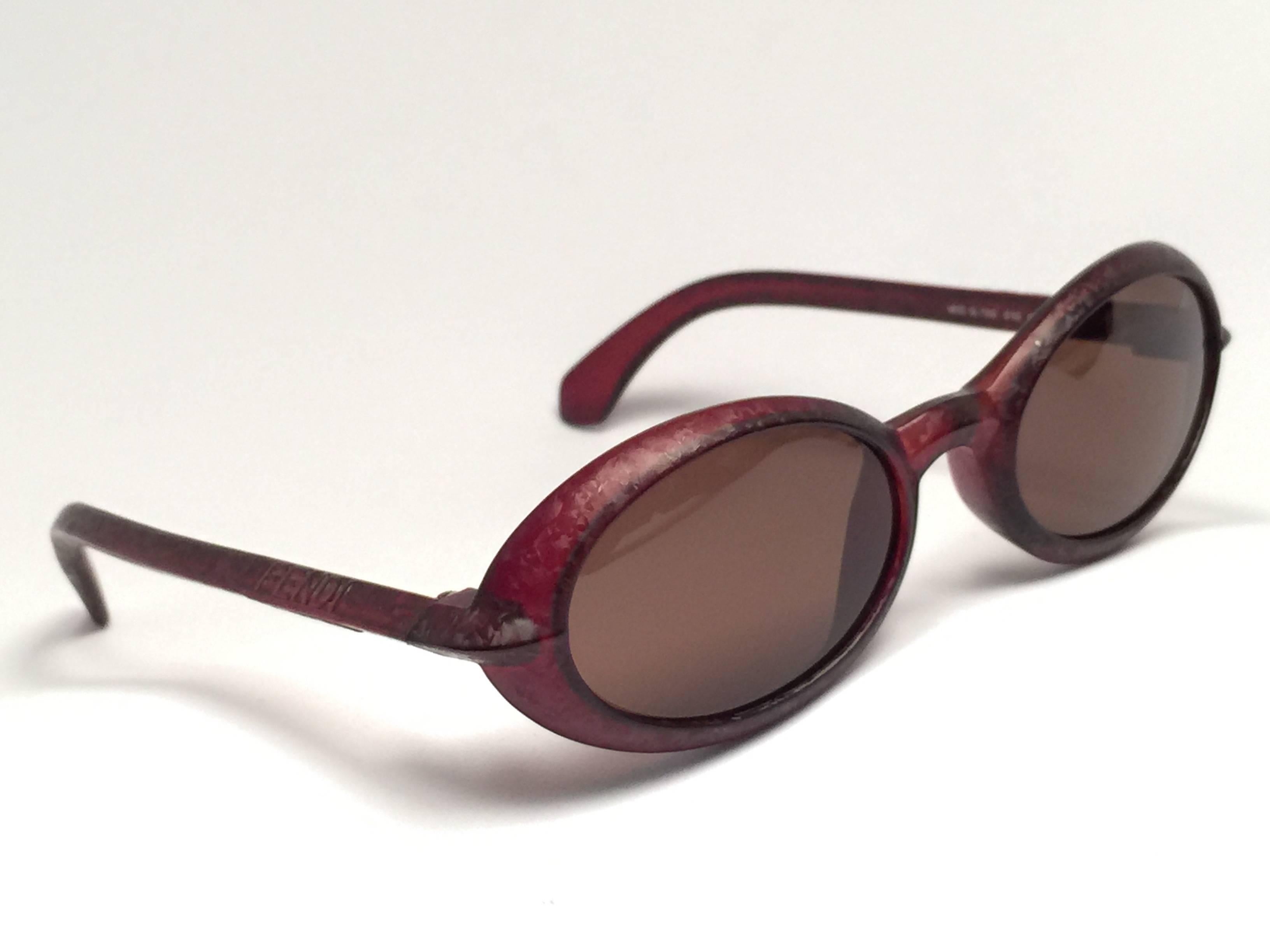 New Fendi textured oval dark red matte frame with brown ( UV protection ) lenses.

Made in Italy.
 
Produced and design in 1990's.

New, never worn or displayed.