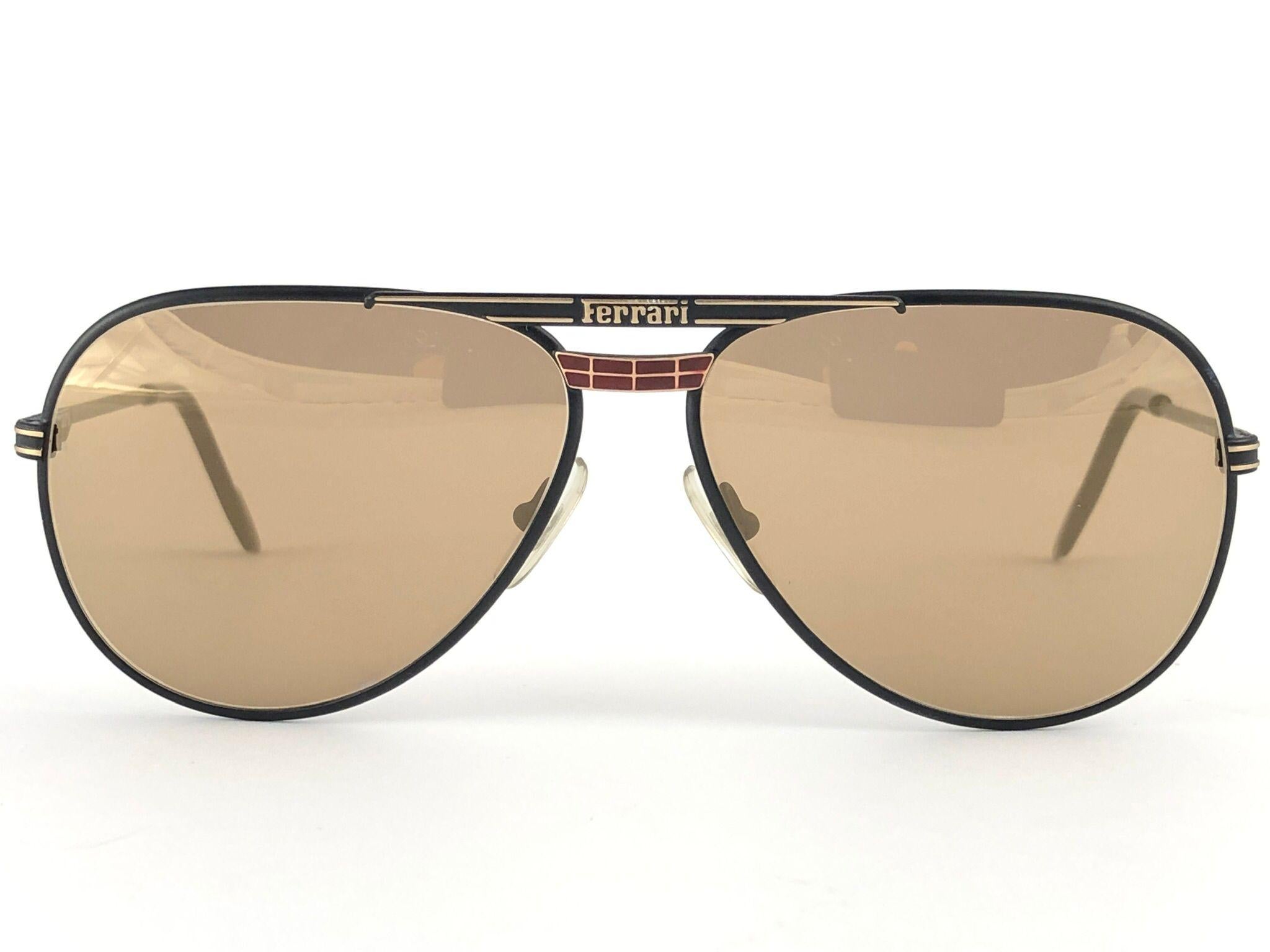New Vintage Ferrari F13 Sunglasses holding a pair of spotless Mirror lenses.

New, never worn or displayed. Comes with its original Ferrari Sleeve and carton box.

This item may show minor sign of wear due to storage.

Made in