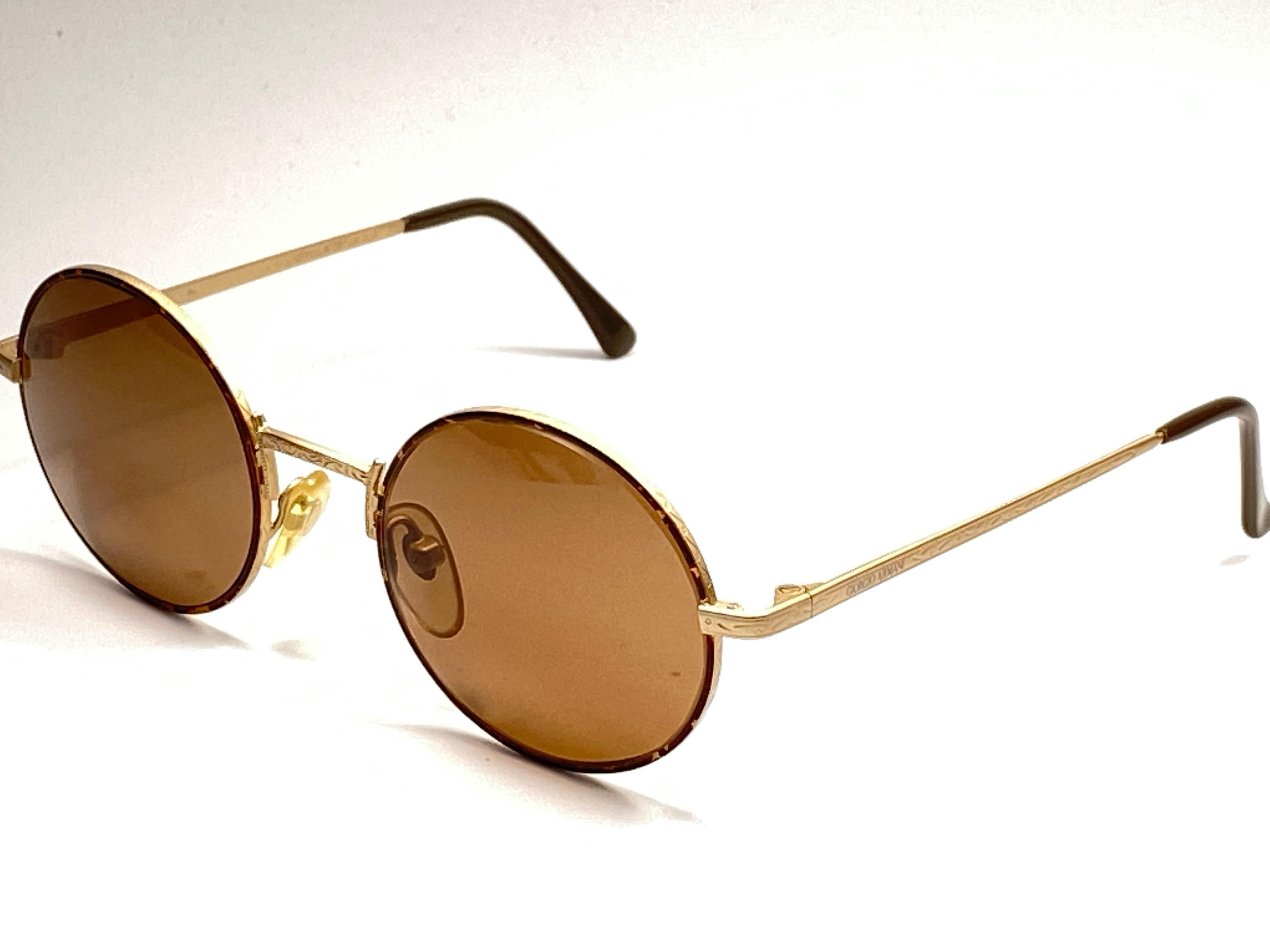 New Vintage Giorgio Armani small oval gold matte frame with G15 brown lenses.

Made in Italy.
 
Produced and design in 1990's.

New, never worn or displayed.

FRONT : 13 cms
LENS HEIGHT : 4.3 CMS
LENS WIDTH : 5 CMS
