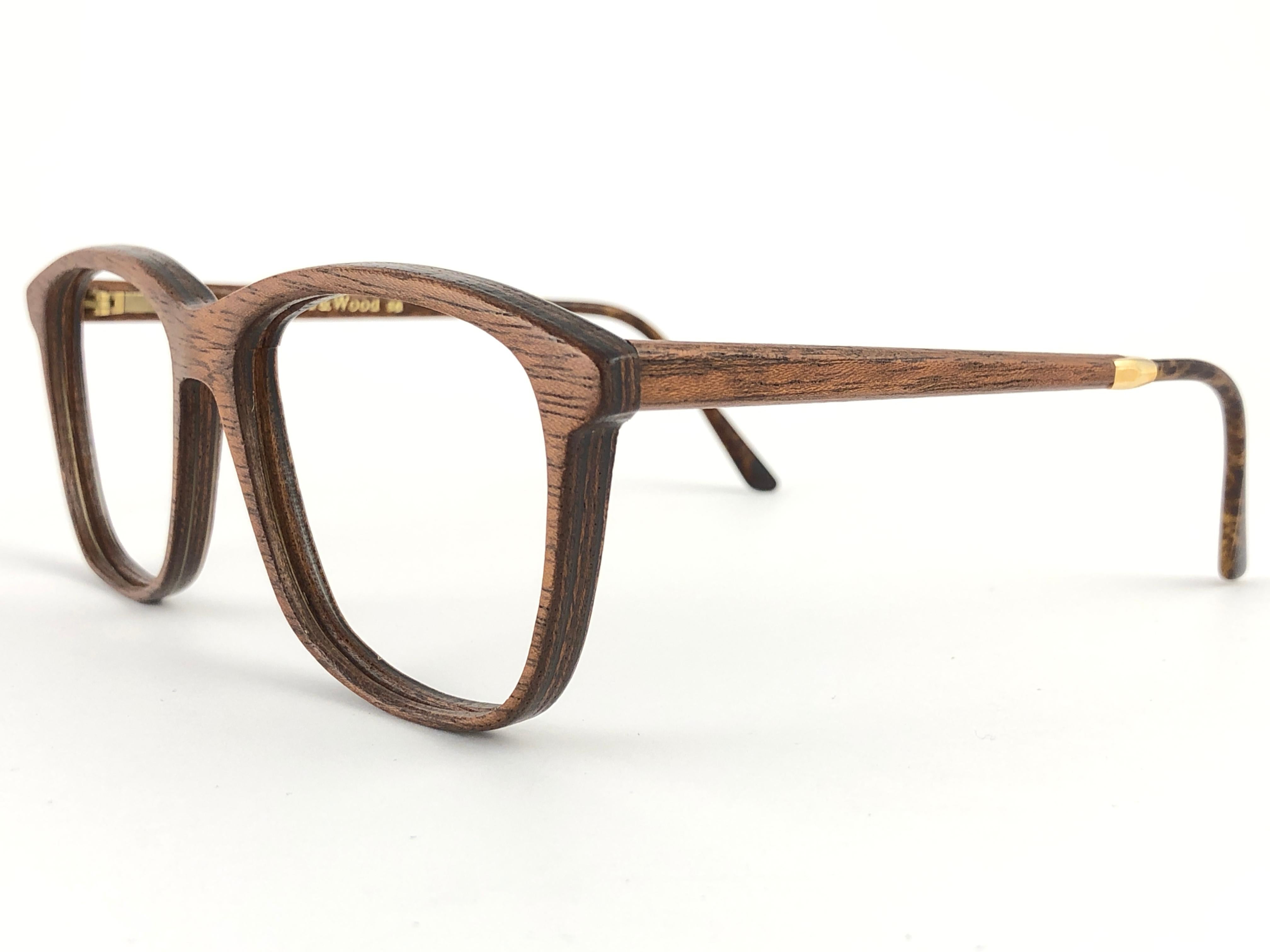 New Vintage Gold & Wood Paris genuine wood frame ready for prescription or reading lenses.
New, never worn or displayed. This pair may have minor sign of wear due to storage. 

Made in France.

Measurements

Frame Width  14.5 cms
Lens Height  4.4