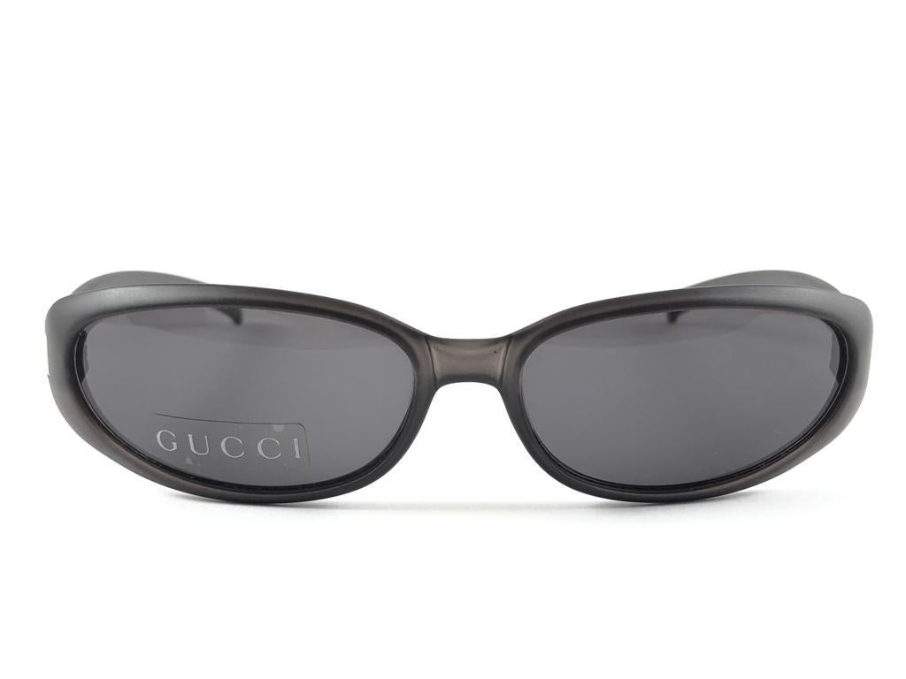 New Vintage Gucci Black Mate Oval Frame with Medium Grey Lenses With Silver Accents. 
New never worn or displayed. 
This item could show minor sign of wear due to nearly 30 years of storage. Made in Italy.

Front                       14   cm
Lens