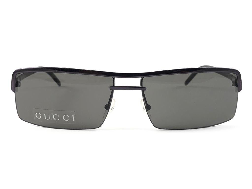New Vintage Gucci Metallic Purple Rectangular Half Frame With Medium Grey Lenses
New never worn or displayed. 
This item could show minor sign of wear due to nearly 30 years of storage. Made in Austria.

Front                     13.5   cm
Lens