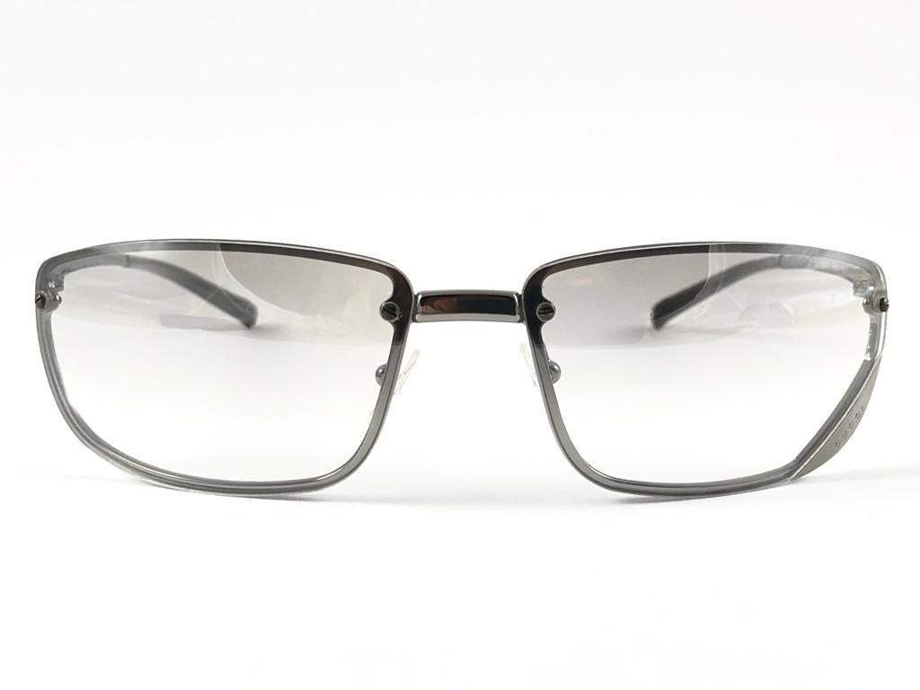 New Vintage Gucci Silver Rectangular Frame with Light Gradient Grey Lenses.
New never worn or displayed. 
This item could show minor sign of wear due to nearly 30 years of storage. Made in Italy.

Front                       13.5   cm
Lens Hight    