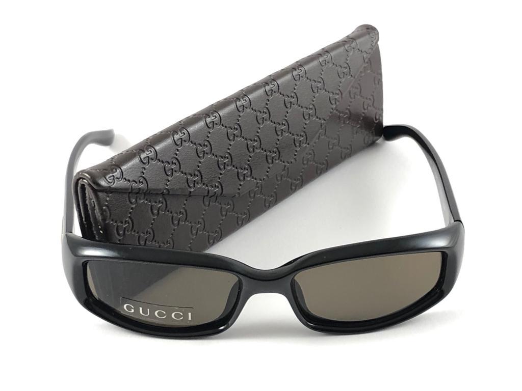 New Vintage Gucci Black Rectangular Optyl Frame with Medium Brown Lenses With Silver Accents. 
New never worn or displayed. 
This item could show minor sign of wear due to nearly 30 years of storage. Made in Italy.

Front                       14  