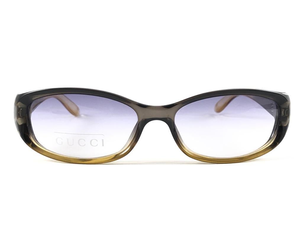 New Vintage Gucci Translucent Two Tone Amber Optyl Frame with Light Purple Gradient Lenses. 
New never worn or displayed. 
This item could show minor sign of wear due to nearly 30 years of storage. Made in Italy.

Front                       14  