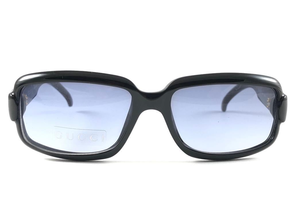 New Vintage Gucci Black Optyl Classic stunning Frame with Light Blue lenses. 
New never worn or displayed. 
This item could show minor sign of wear due to nearly 30 years of storage. Made in Italy.

Front                       13.5   cm
Lens Hight  