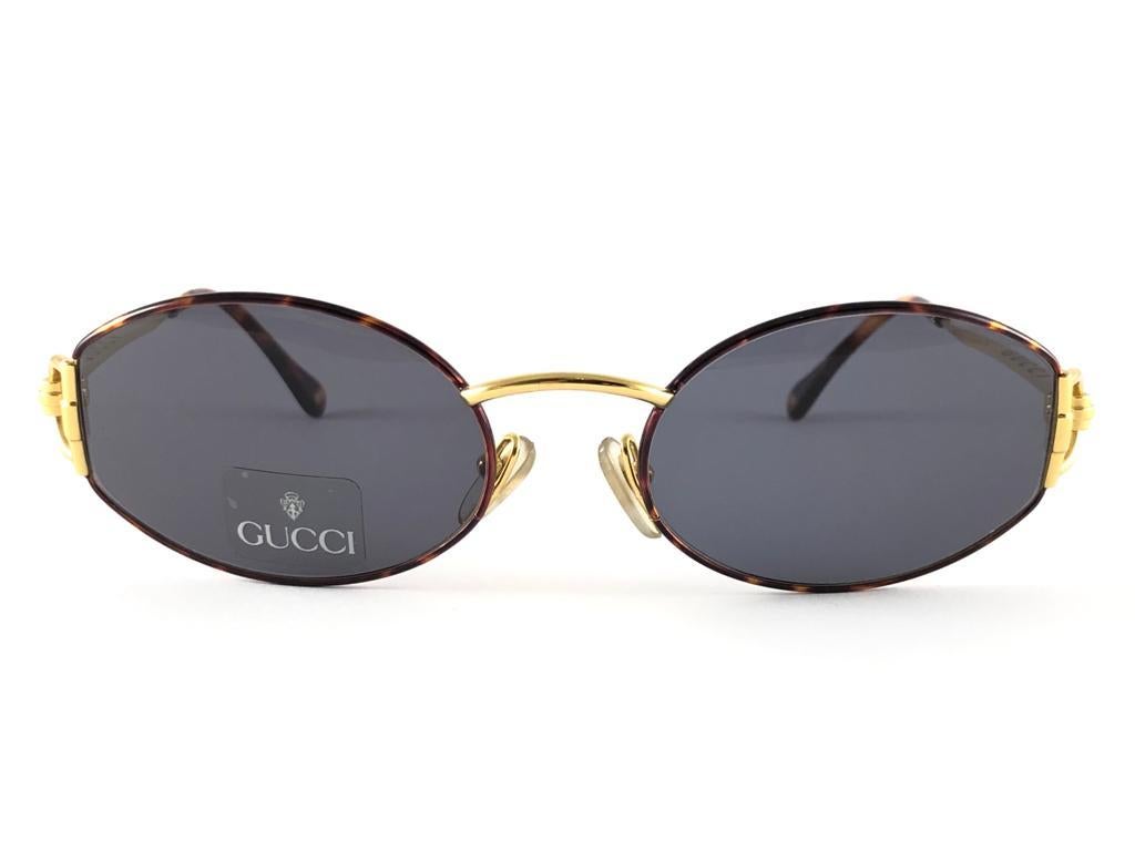 New Vintage Gucci oval frame tortoise and gold with dark grey lenses.
New never worn or displayed. 
This item could show minor sign of wear due to nearly 30 years of storage. Made in Italy.


Front                       14     cm
Lens Hight         