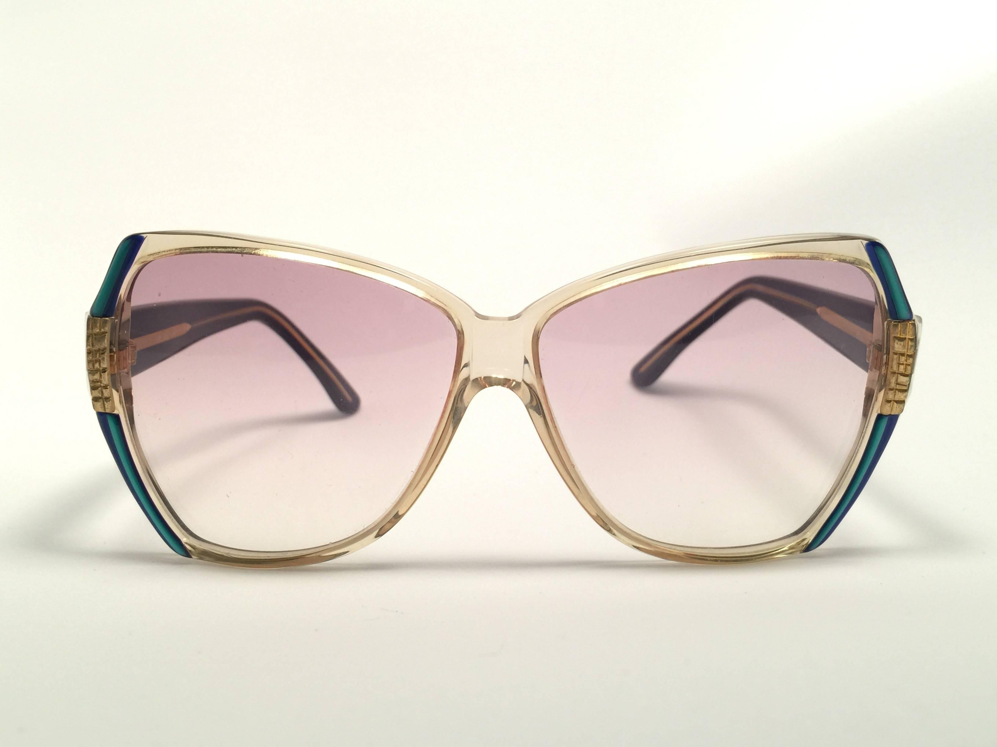 New Vintage Gucci translucent with turquoise and gold details frame. 
Spotless lenses.  
New never worn or displayed. This item could show minor sign of wear due to nearly 30 years of storage. Made in Italy.
