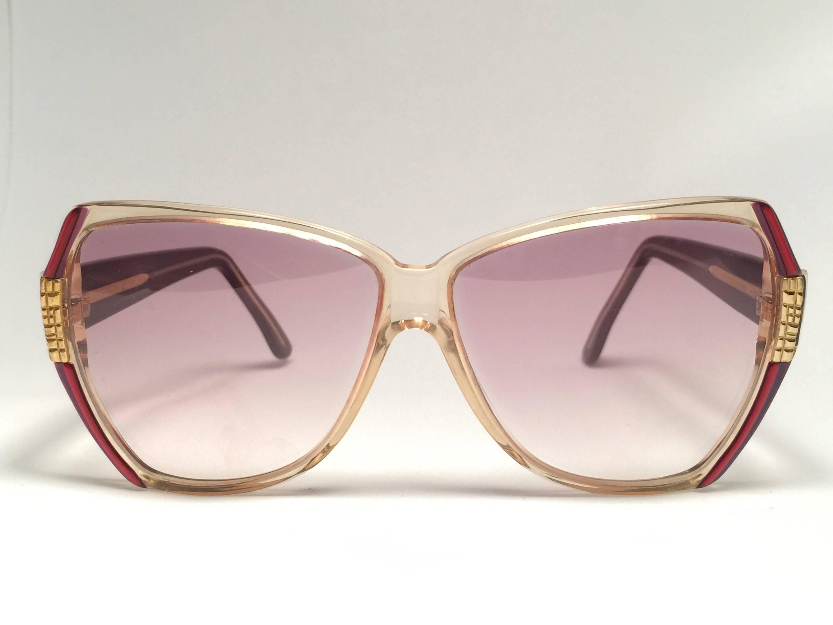 New Vintage Gucci translucent with red and gold details frame. 
Spotless lenses.  
New never worn or displayed. This item could show minor sign of wear due to nearly 30 years of storage. Made in Italy.