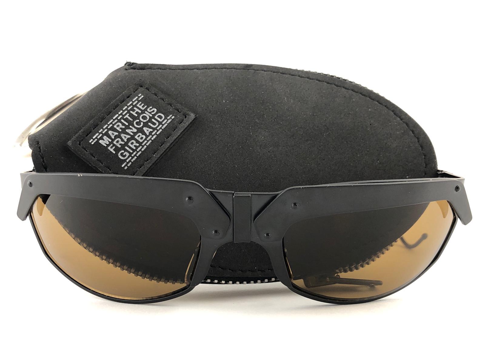 

Precious limited edition IDC G2 Pour Marithe Francois Girbaud Black mate sunglasses holding a spotless pair of brown lenses. Curled temples for a fashionable yet comfortable wear.

New, never worn or displayed. This pair could show minor sign of
