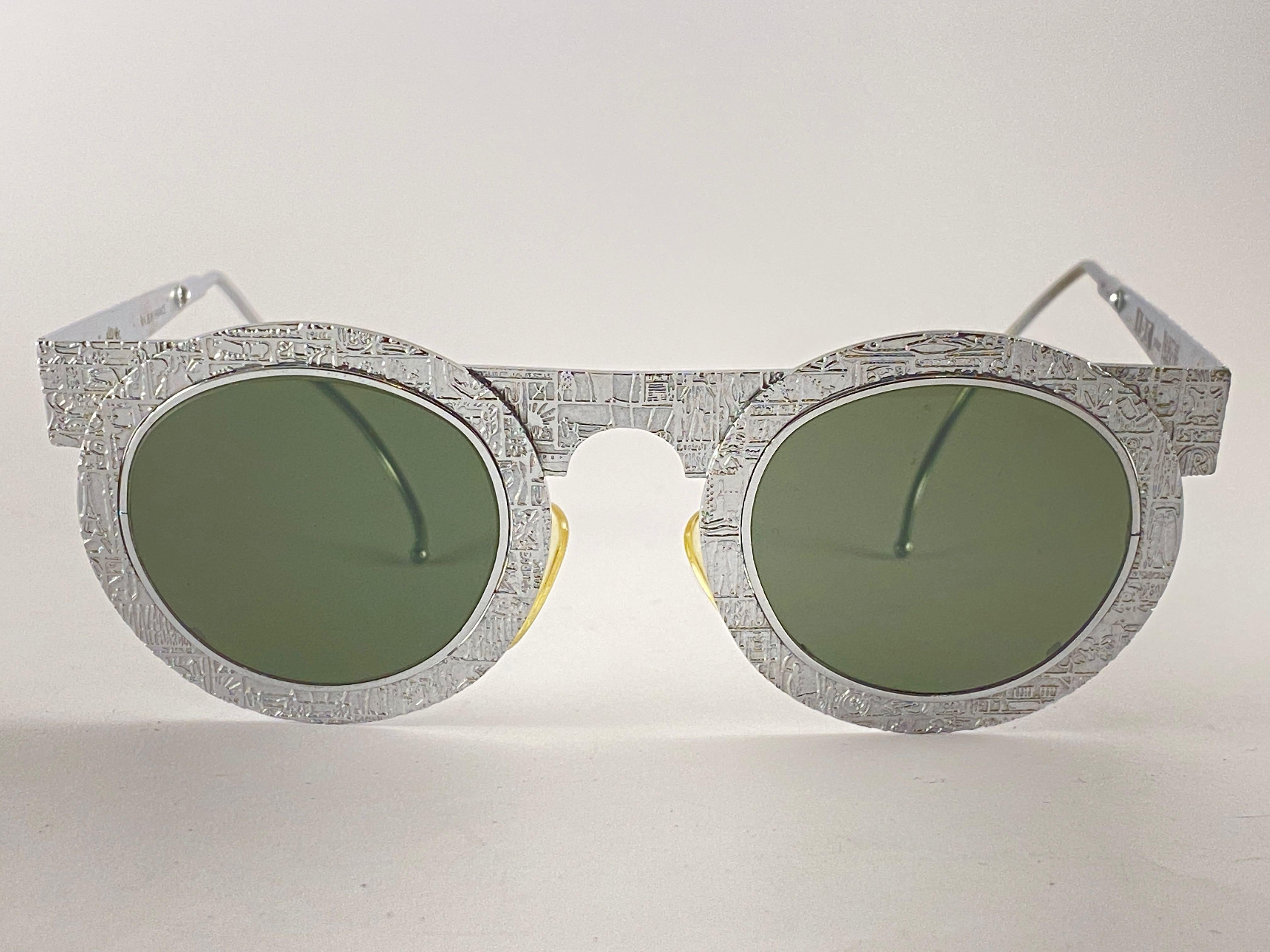 

IDC Pour Marithe Francois Girbaud round silver with engraved accents sunglasses holding a spotless pair of dark grey lenses. Curled temples for a fashionable yet comfortable wear.

New, never worn or displayed. This pair could show minor sign of