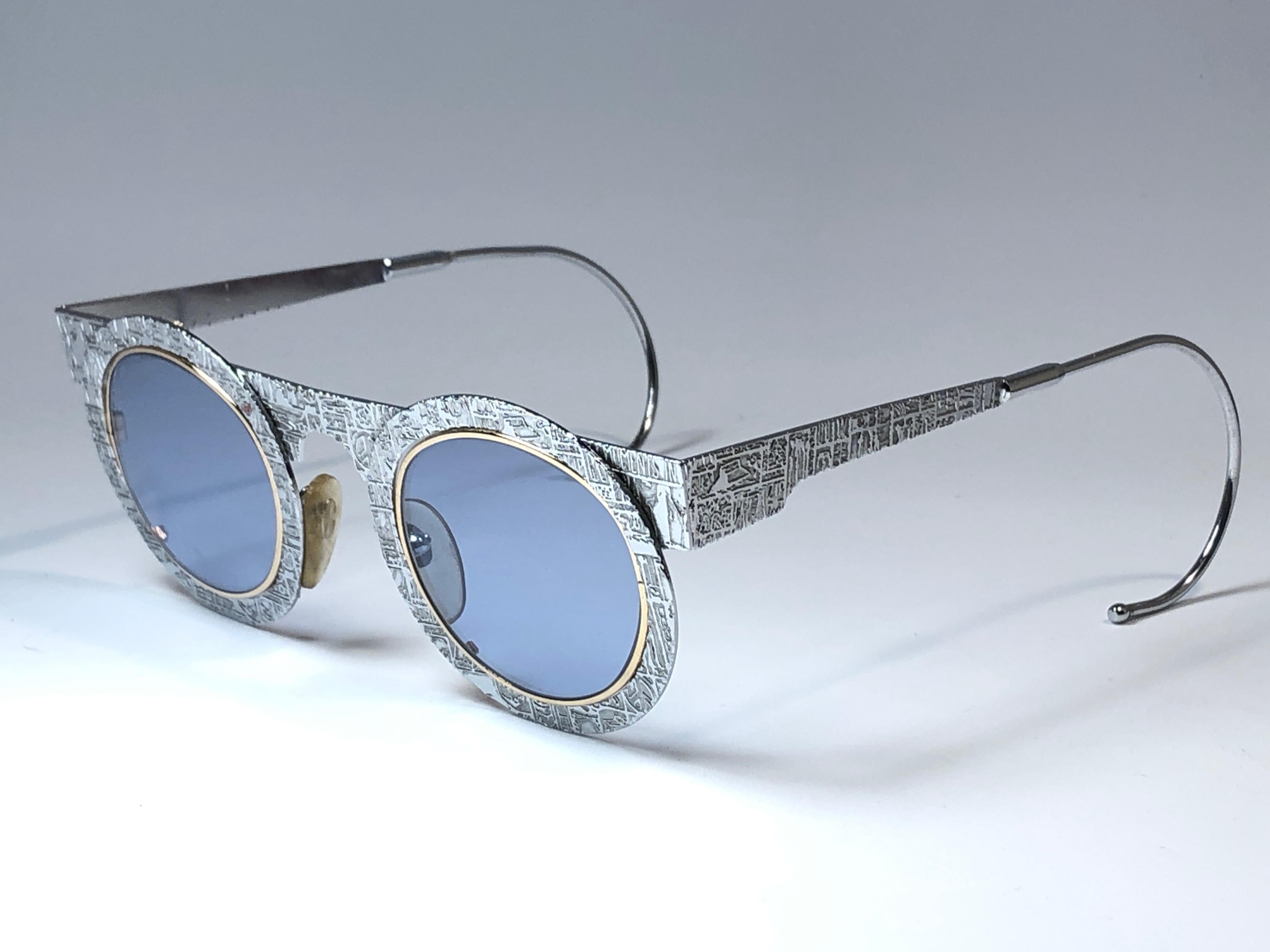 

IDC Pour Marithe Francois Girbaud round silver with engraved accents sunglasses holding a spotless pair of Lligh lenses. Curled temples for a fashionable yet comfortable wear.

New, never worn or displayed. This pair could show minor sign of wear