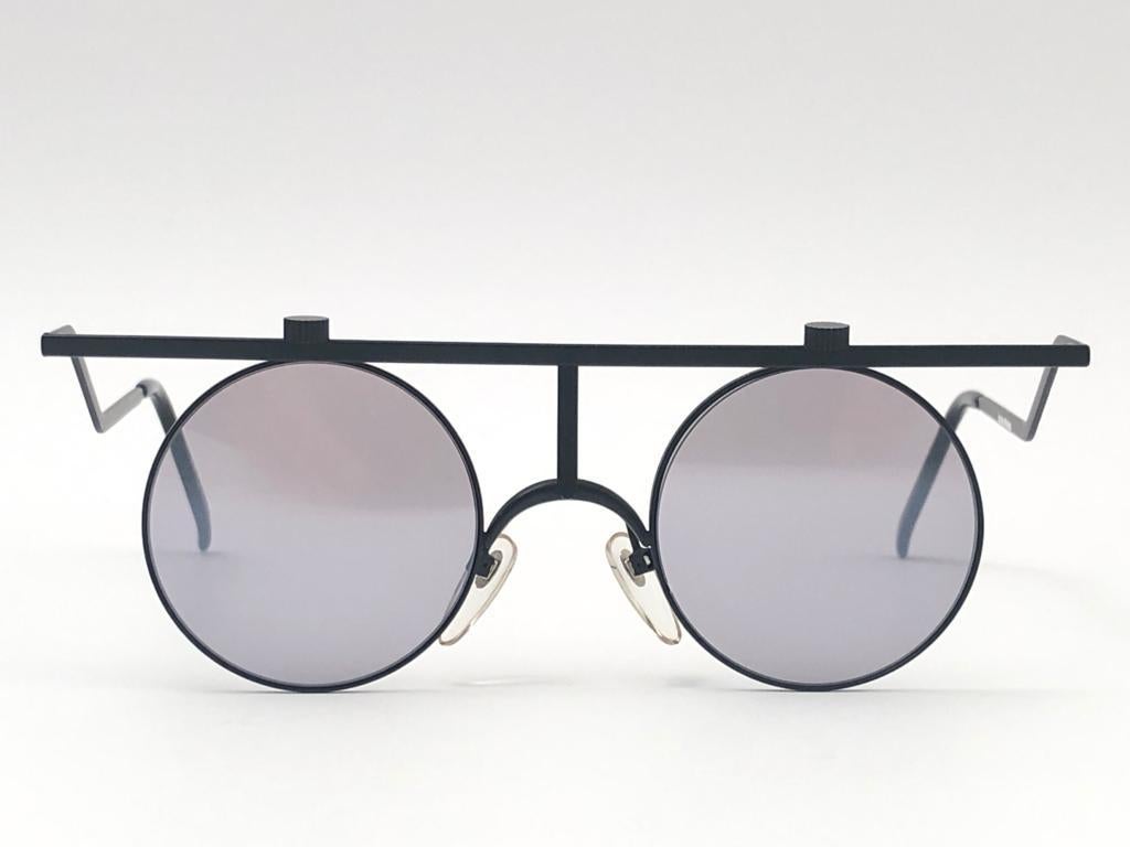 
Released in 1985, extremely rare and coveted. 

Its simple design of a line and two circles was considered a disruptive design at the time. After almost 40 years, the im-101 still remains one of the most iconic model of eyewear  & fashion  history,