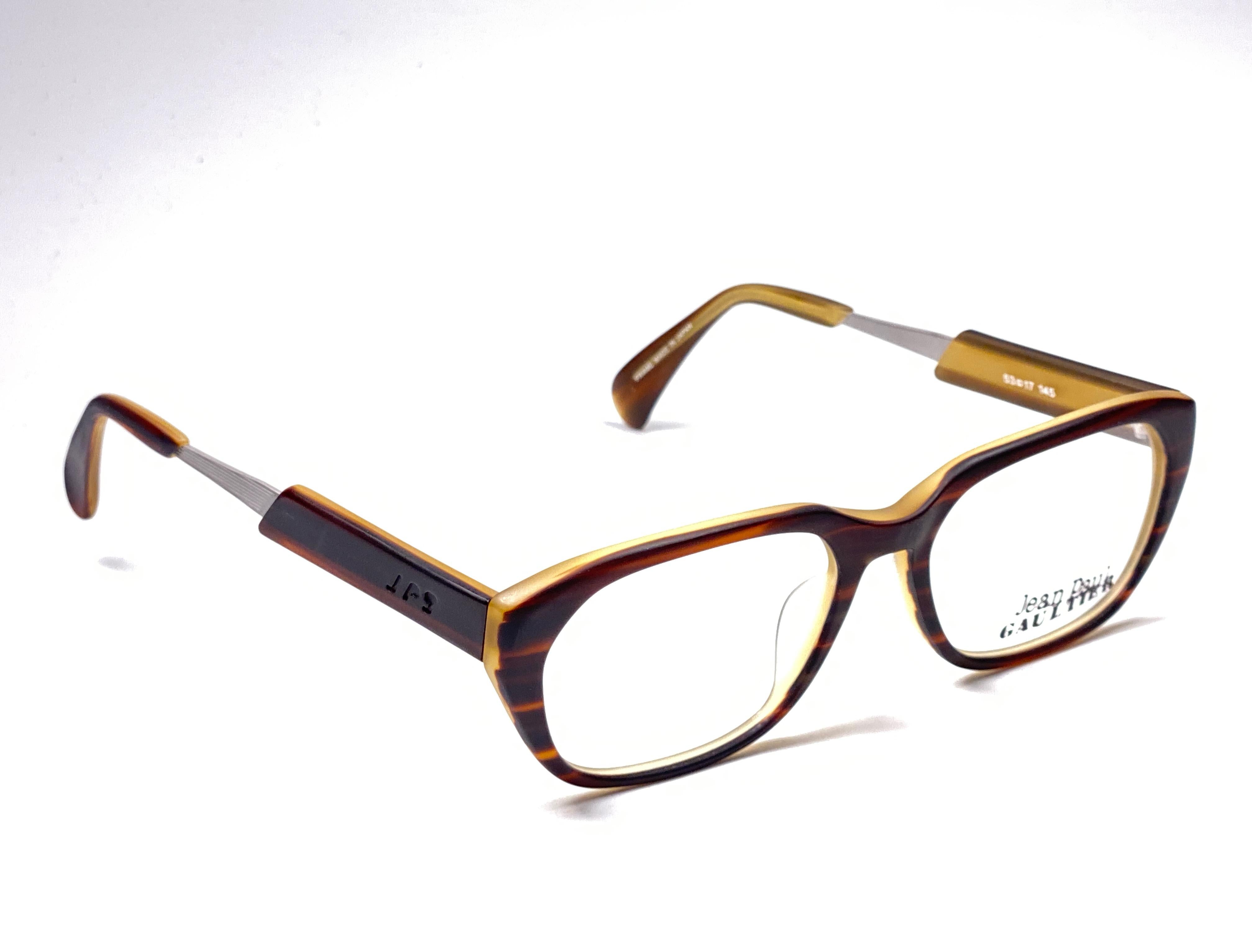 New Vintage Jean Paul Gaultier Junior medium frame in amber tortoise pattern.

Design and produced in the 1900's a timeless and iconic piece.
Ready for prescription lenses.
A true fashion statement.

FRONT : 13.5 CMS

LENS HEIGHT : 4 CMS

LENS WIDTH