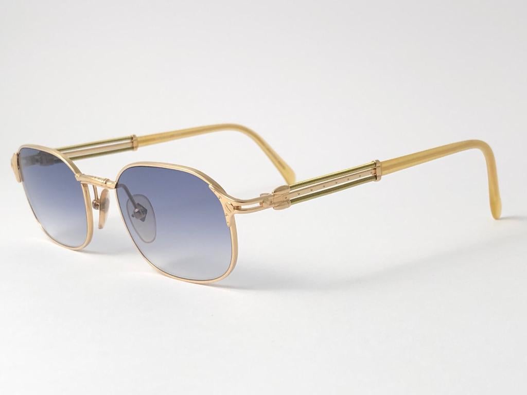 New Jean Paul Gaultier 55 5107 sleek frame. 
Gradient light Blue lenses that complete a ready to wear JPG look. 
Amazing design with strong yet intricate details. 
Design and produced in the 1990's. New, never worn or displayed.
A true fashion
