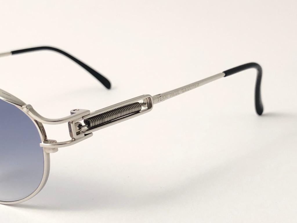 New Jean Paul Gaultier 55 5109 Silver Oval frame. 
Gradient Light Blue lenses that complete a ready to wear JPG look. 
Amazing design with strong yet intricate details. 
Design and produced in the 1990's. New, never worn or displayed.
A true fashion