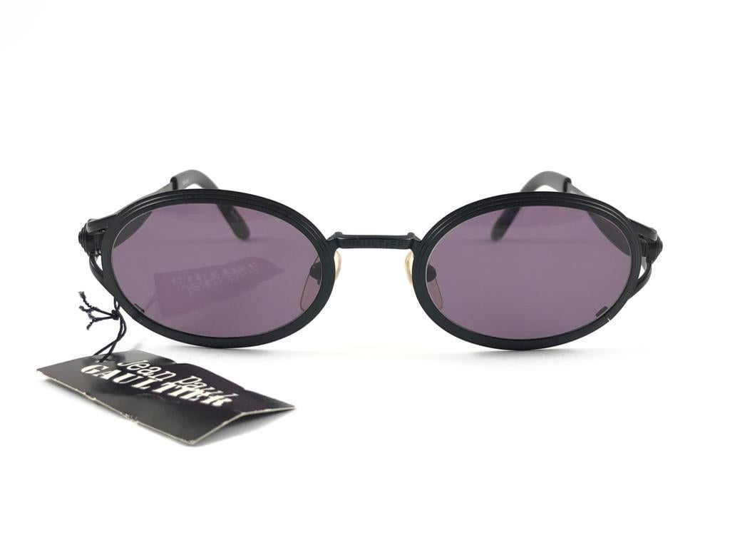 New Jean Paul Gaultier Black Frame.

Temples Decorated With Translucent Red Stripes And Medium Purple Lenses That Complete A Ready To Wear Jpg Look. 

Amazing Design With Strong And Elaborated Details. Made In The 1990'S. 

New, Never Worn Or