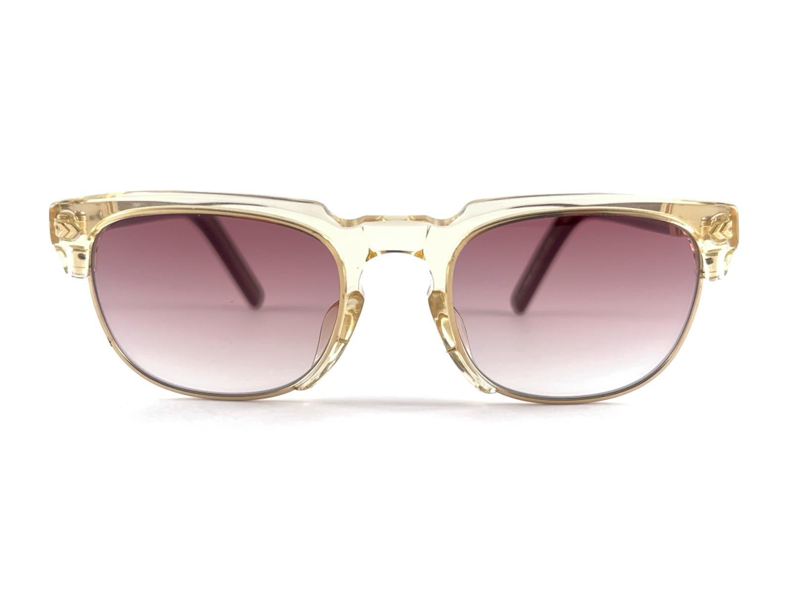 
New Vintage Jean Paul Gaultier Junior Medium Translucent Frame Holding A Pair Of Purple Gradient Lenses
Design And Produced In The 1990's A Timeless And Iconic Piece.
A True Fashion Statement



Made In Japan 



Front                              