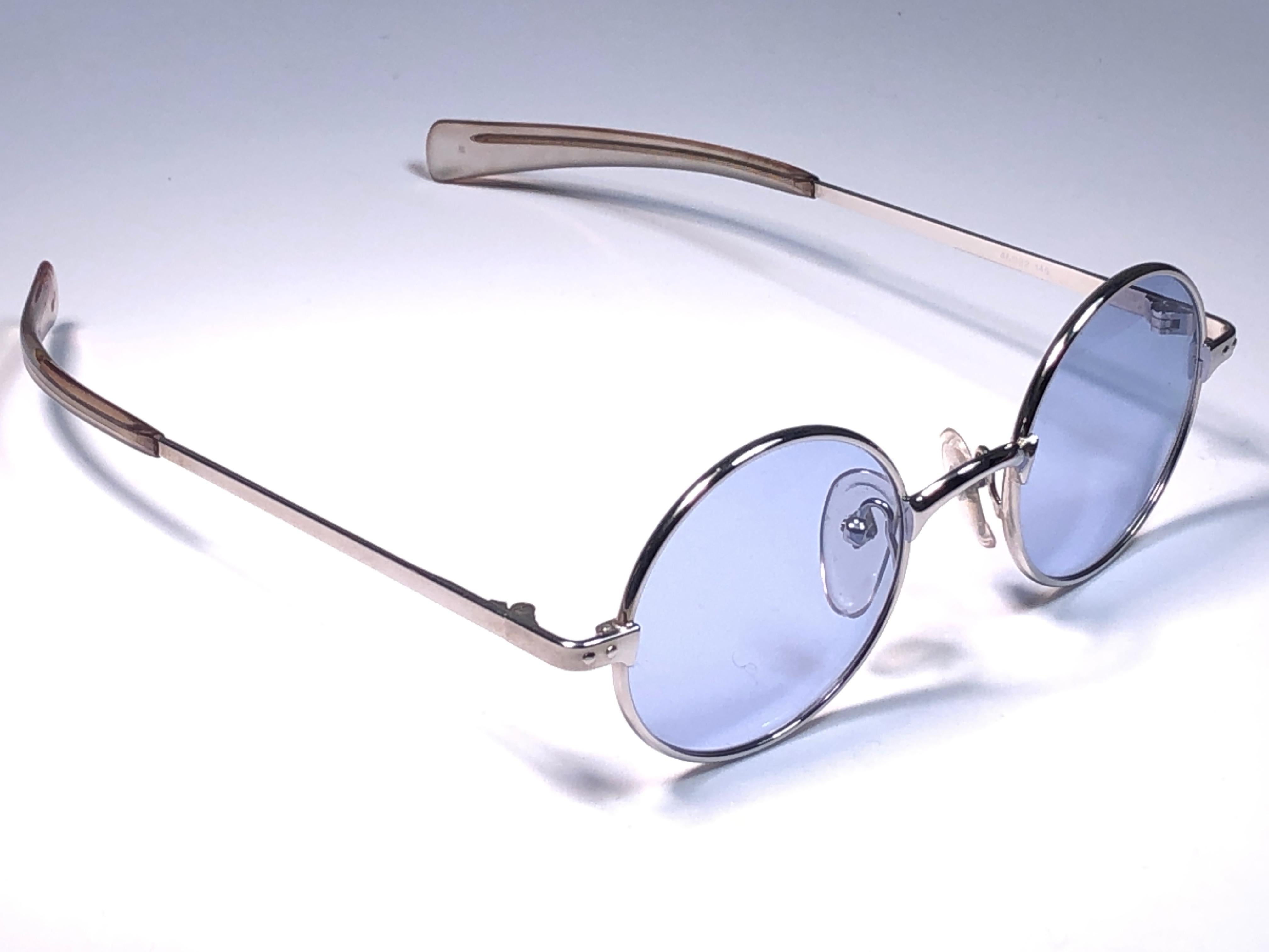 Neu Vintage Jean Paul Gaultier Junior 57 0173 silbernen Rahmen.
Makellose blaue Gläser.
Um 1900 entworfen und hergestellt, ein zeitloses und ikonisches Stück.
Geringe lagerungsbedingte Gebrauchsspuren.
Ein echtes Modestatement.

MASSNAHMEN  
FRONT