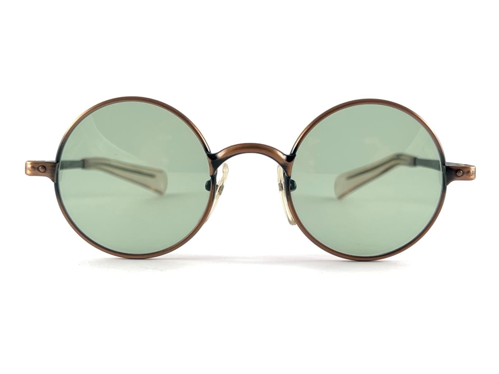 New Vintage Jean Paul Gaultier Junior 57 0173 Copper frame.
Spotless green lenses.
Design and produced in the 1990's a timeless and iconic piece.
Minor sign of wear due to storage.
A true fashion statement.


Measurements


Front                    