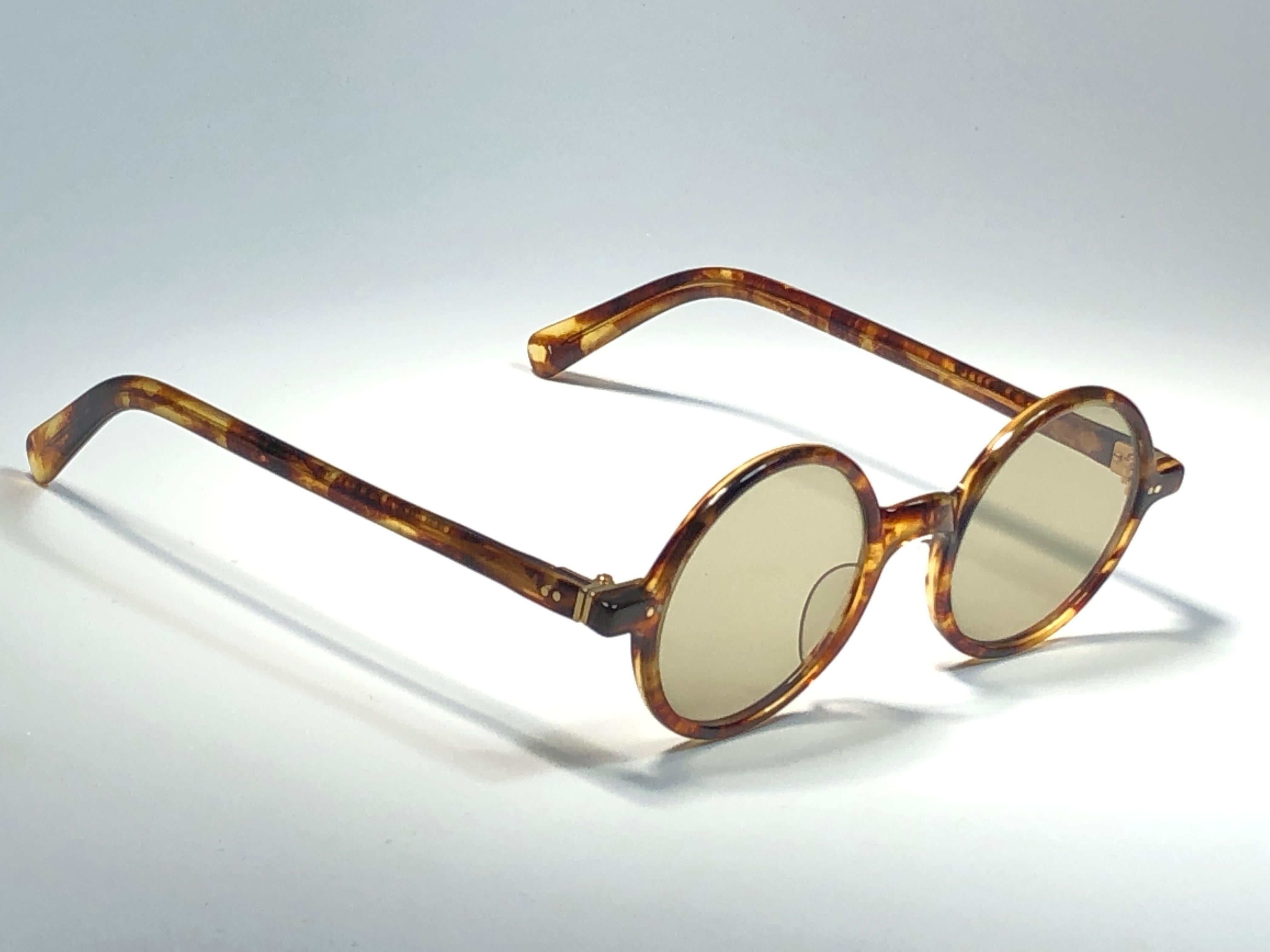 New Vintage Jean Paul Gaultier Junior 58 0072 XS Small frame in amber tortoise pattern.
Flat lenses for aa complete JPG look. 
The same model worn by Jean Reno in Luc Besson's, Leon The Professional.
Design and produced in the 1900's a timeless and